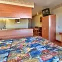 Bedroom, Kitchen/Kitchenette in Western Skies Inn & Suites