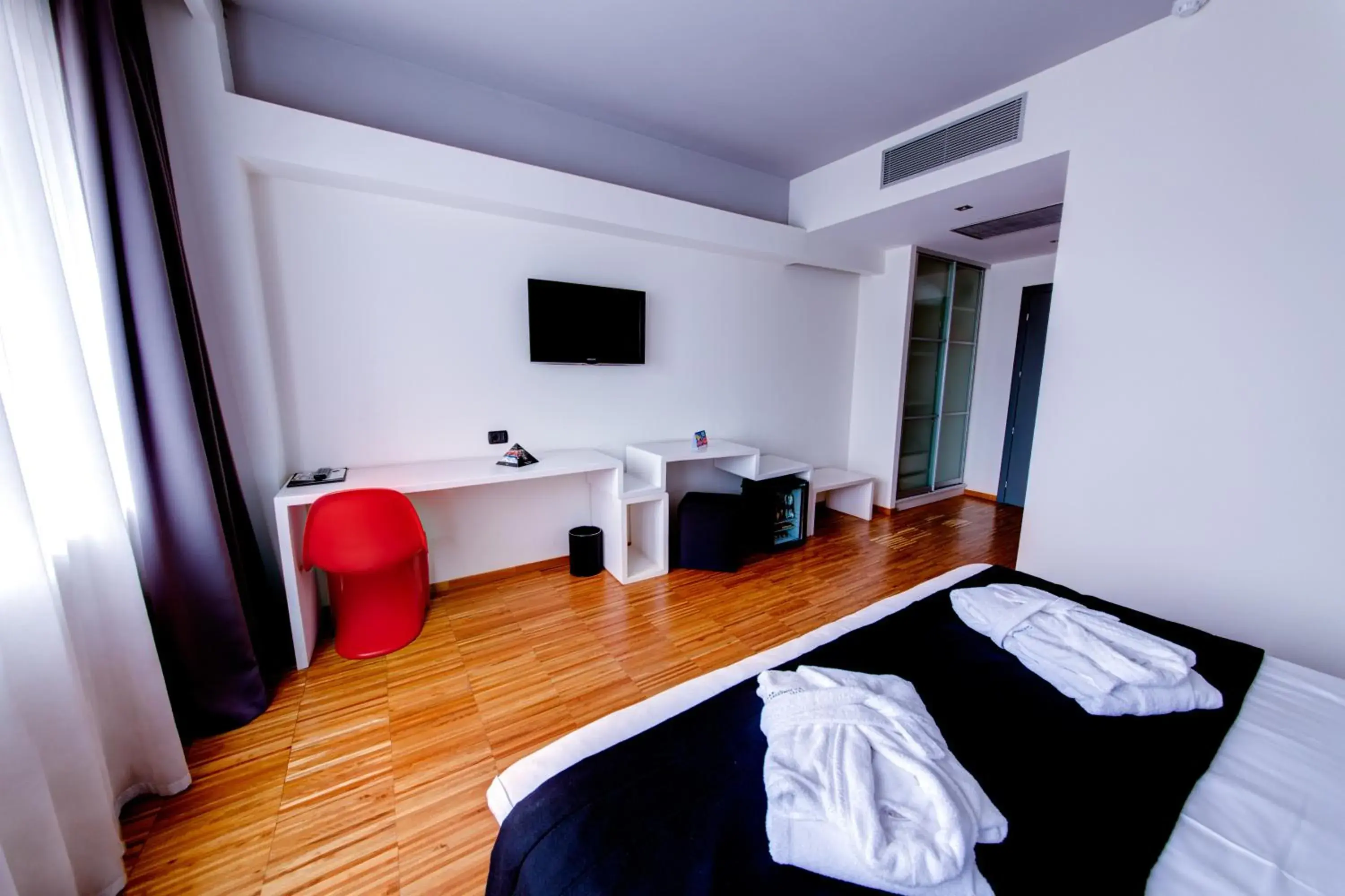 Photo of the whole room, TV/Entertainment Center in Sarroglia Hotel
