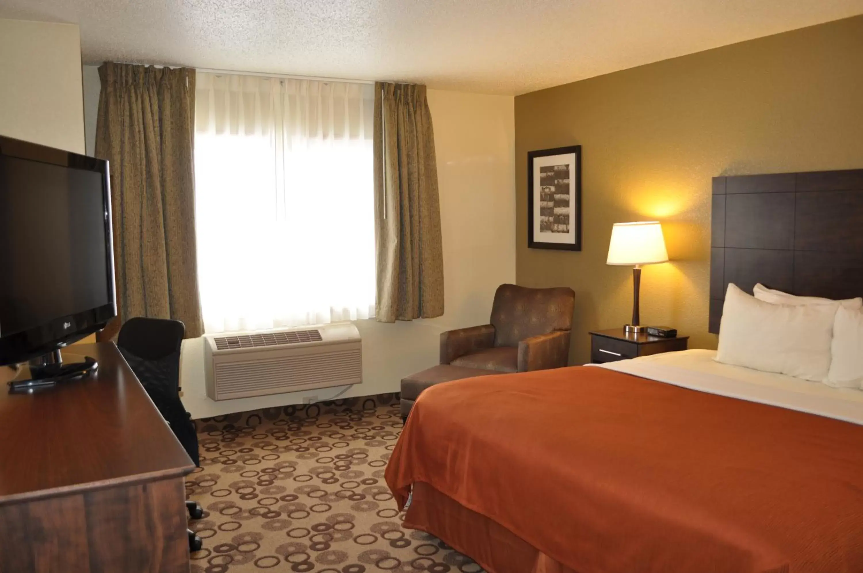 Bed in AmericInn by Wyndham Cedar Falls