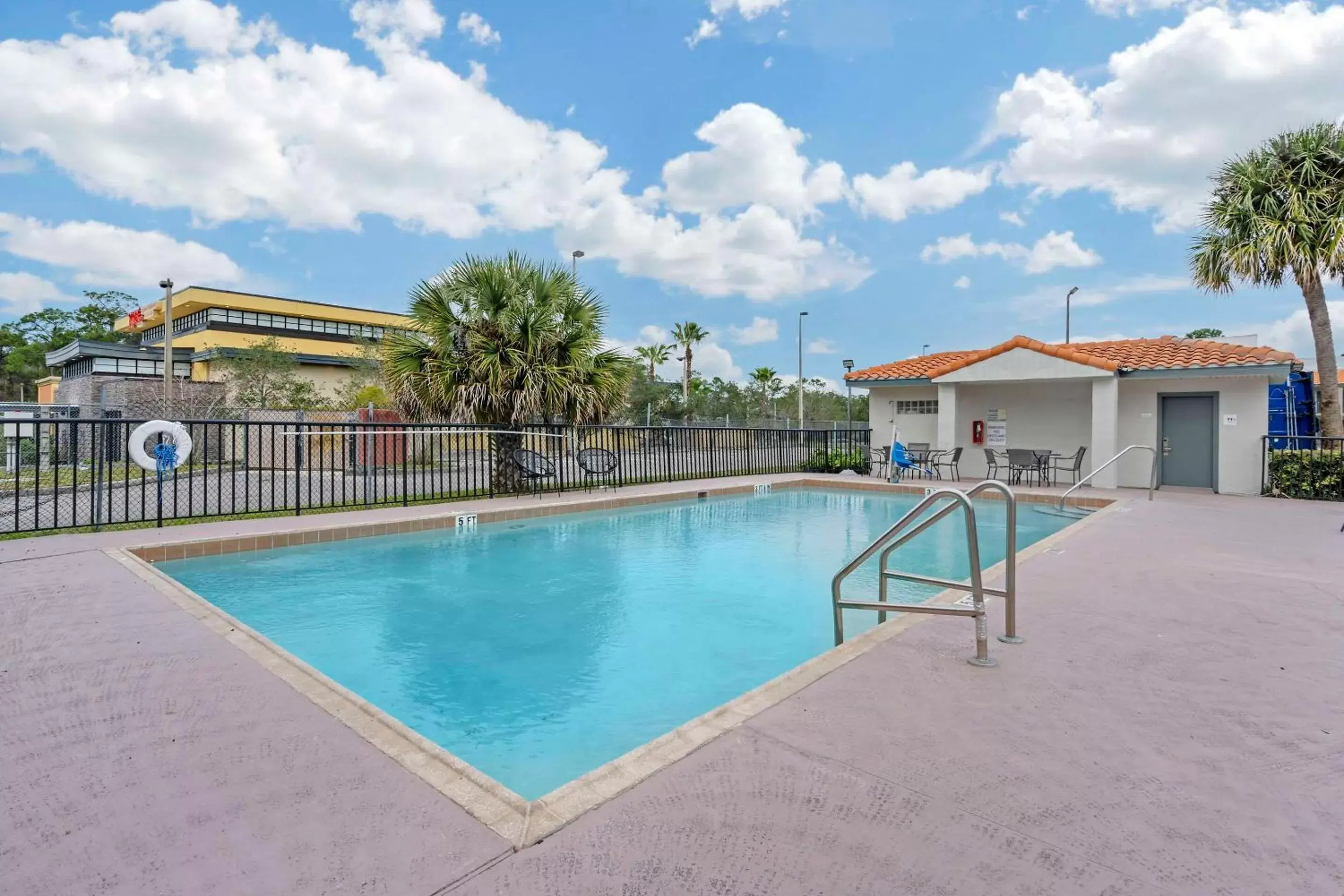 Swimming Pool in Days Inn & Suites by Wyndham Orlando East UCF Area