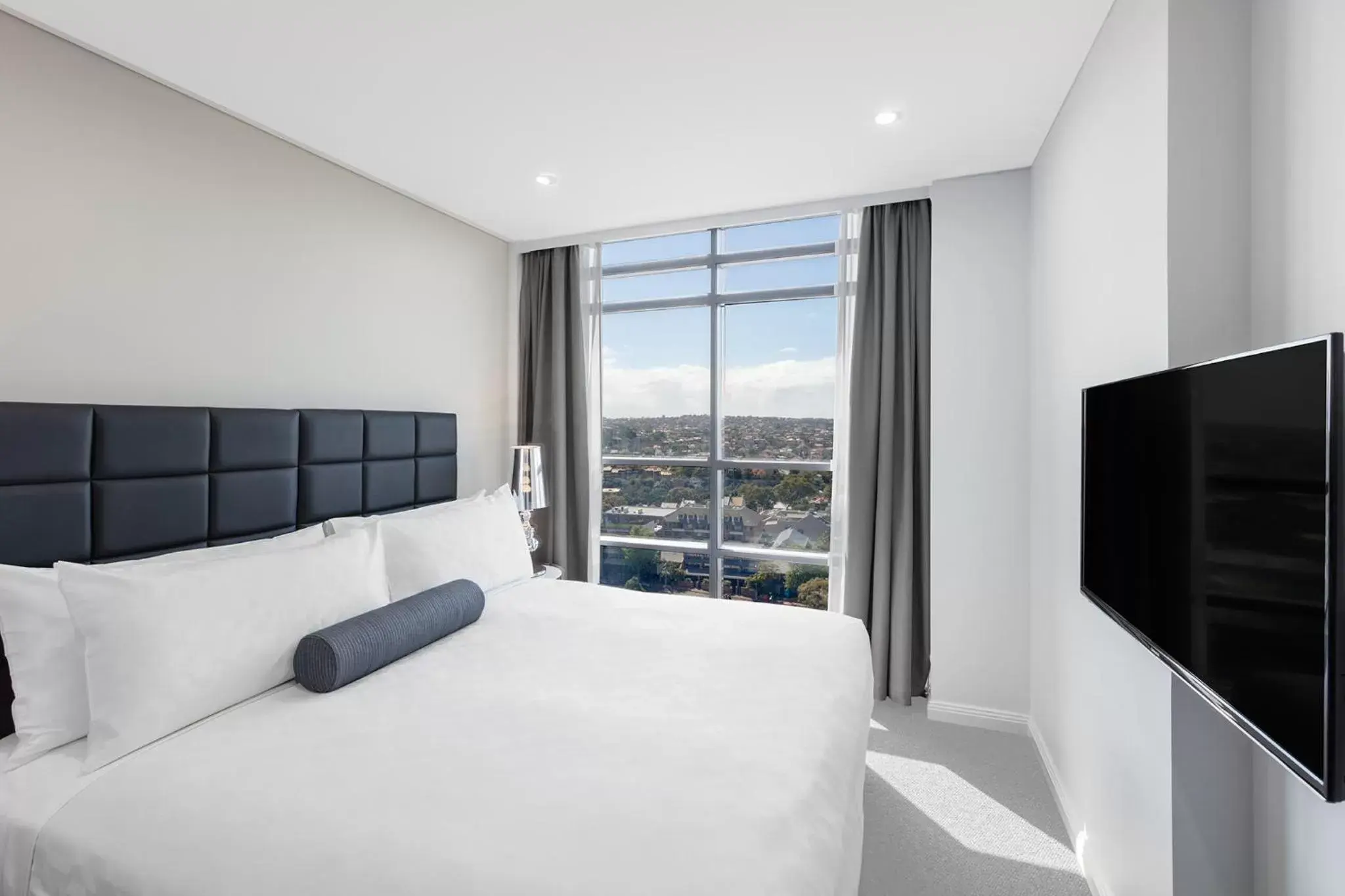 Bed in Meriton Suites North Sydney