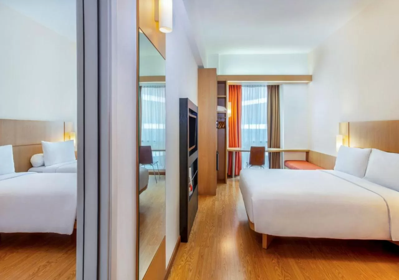 Family Room with Queen Bed and Two Single Beds in Ibis Bandung Trans Studio