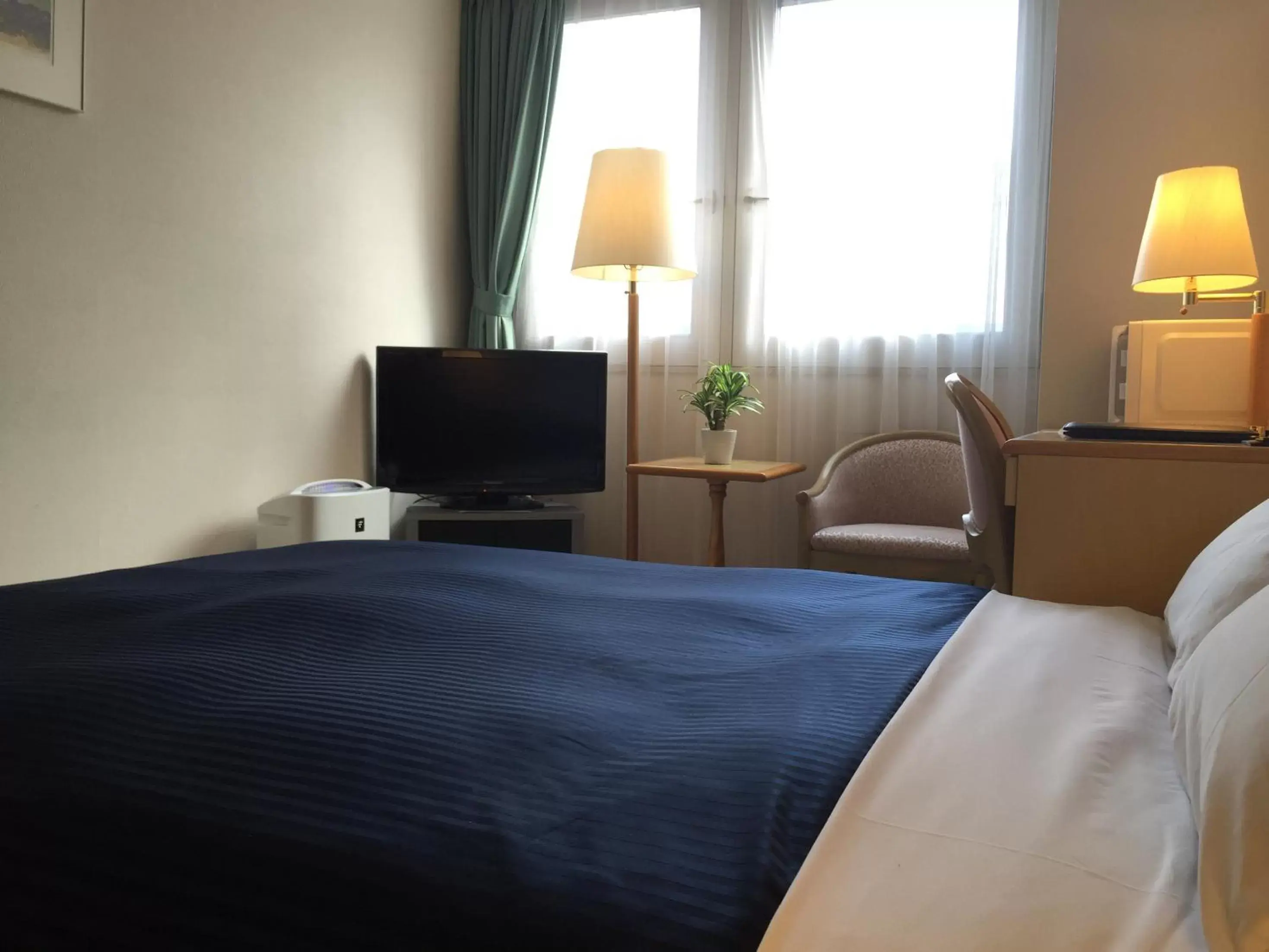 Photo of the whole room, Bed in HOTEL LiVEMAX Sapporo Ekimae