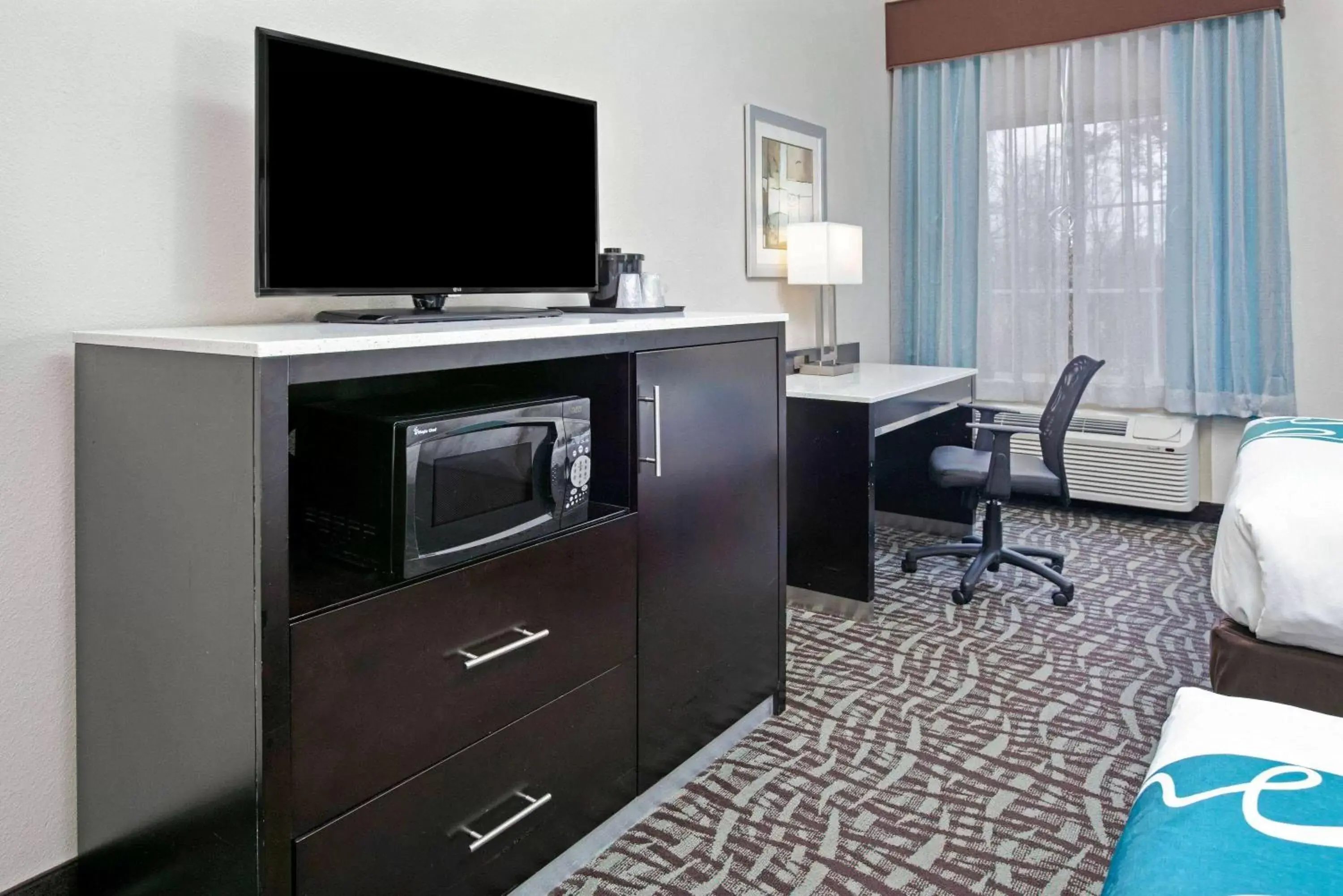 Photo of the whole room, TV/Entertainment Center in La Quinta Inn and Suites by Wyndham Paris