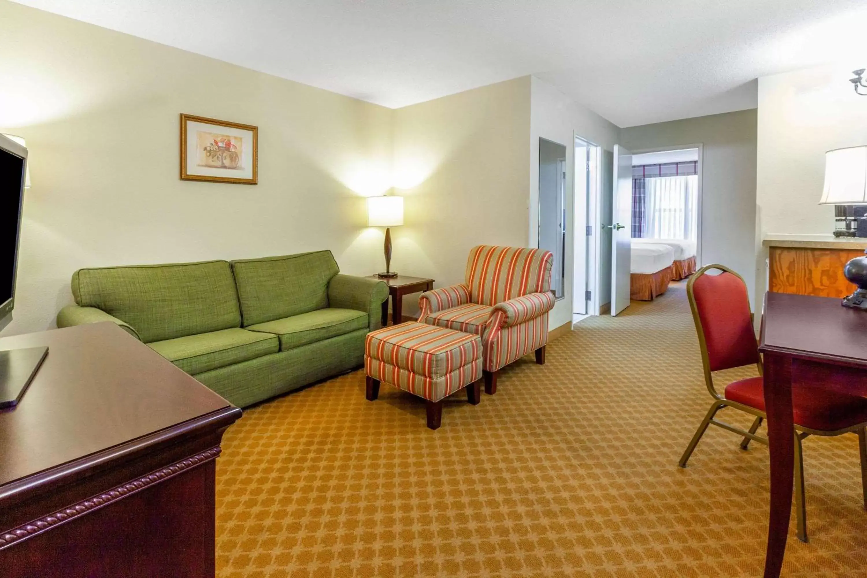 Photo of the whole room, Seating Area in AmericInn by Wyndham Iron Mountain