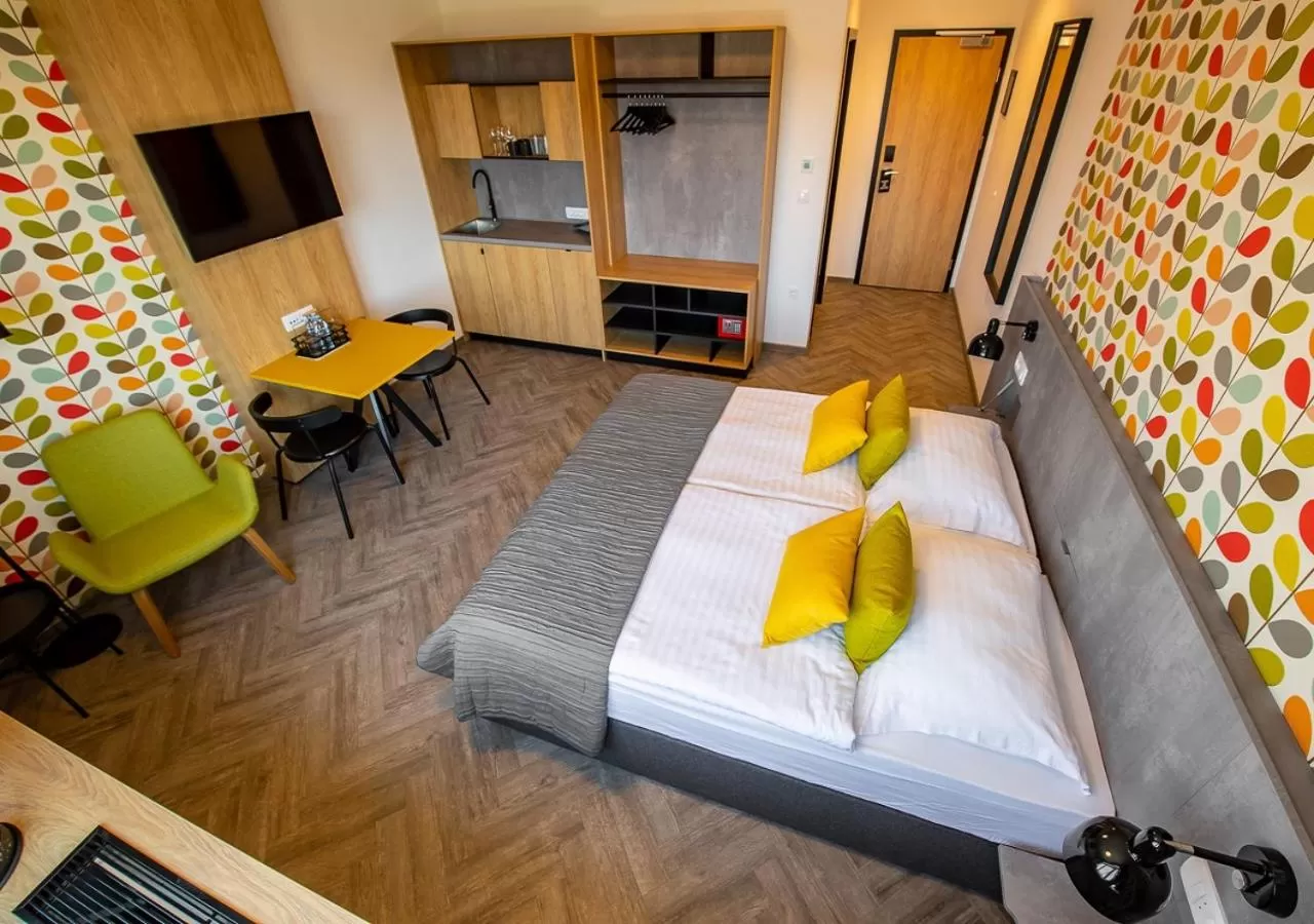 Kitchen or kitchenette, Bed in Urban Ring Hotel