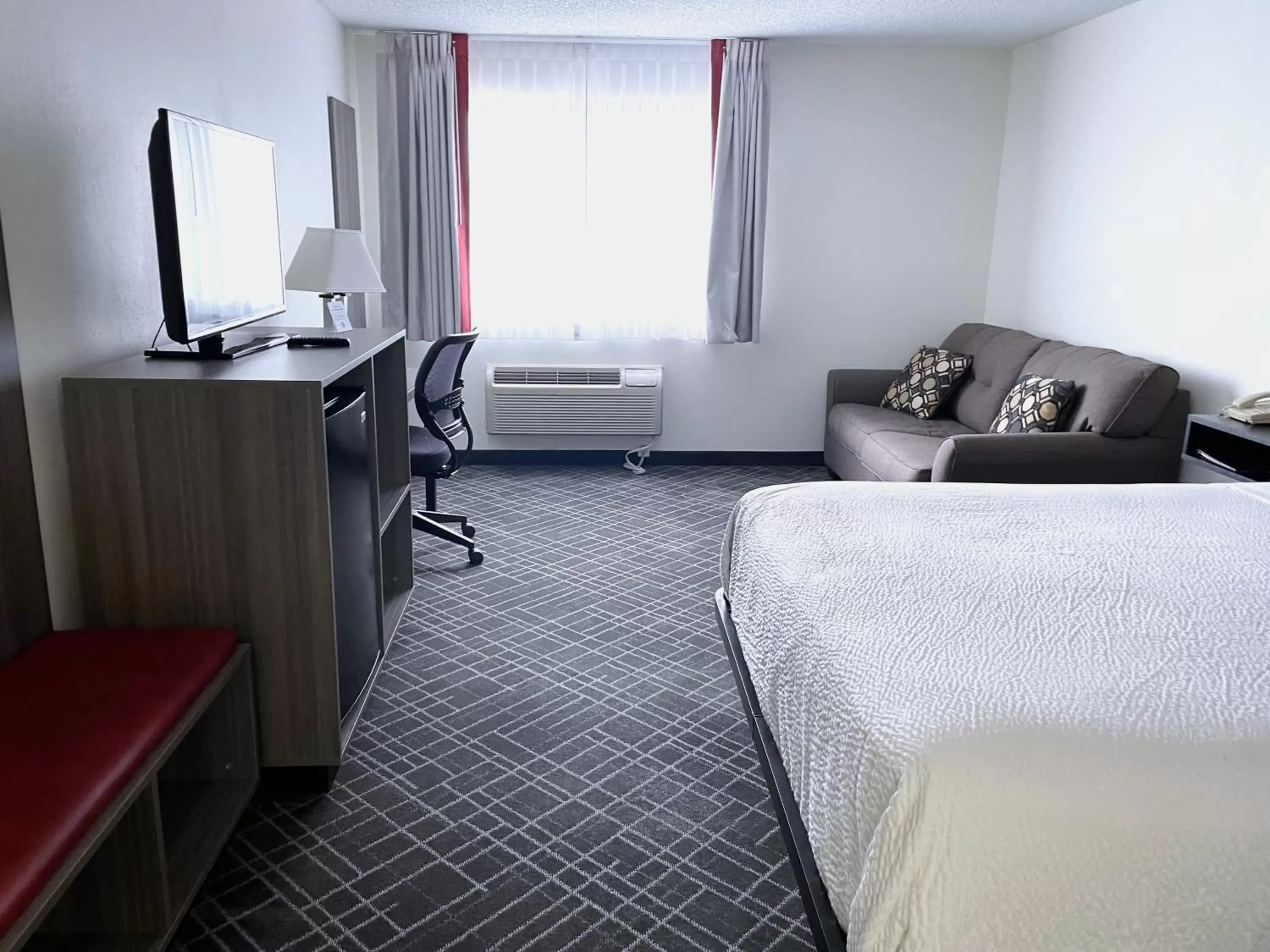 Bed, Seating Area in Ramada by Wyndham Waupaca