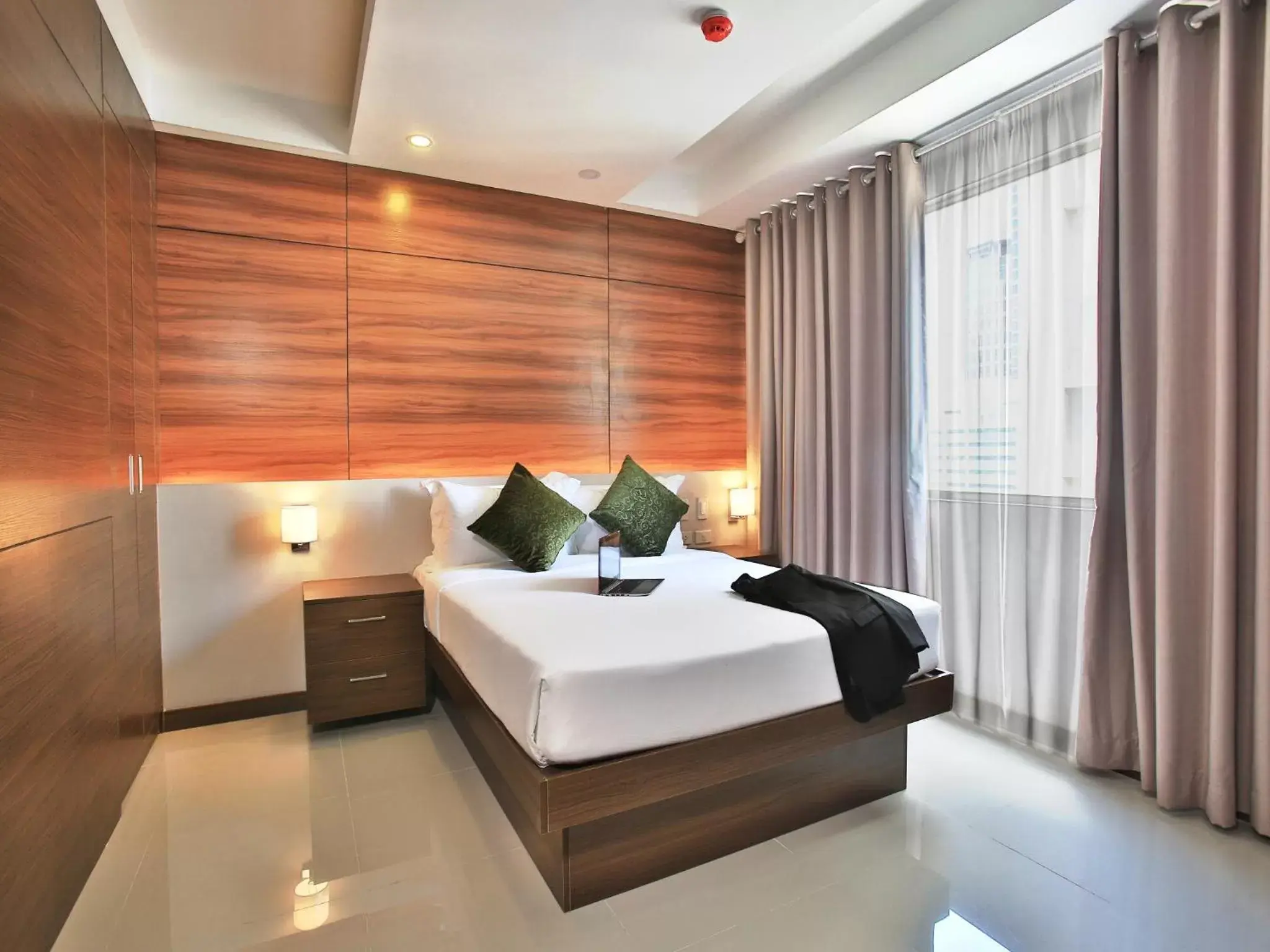 Bed in Valero Grand Suites by Swiss-Belhotel