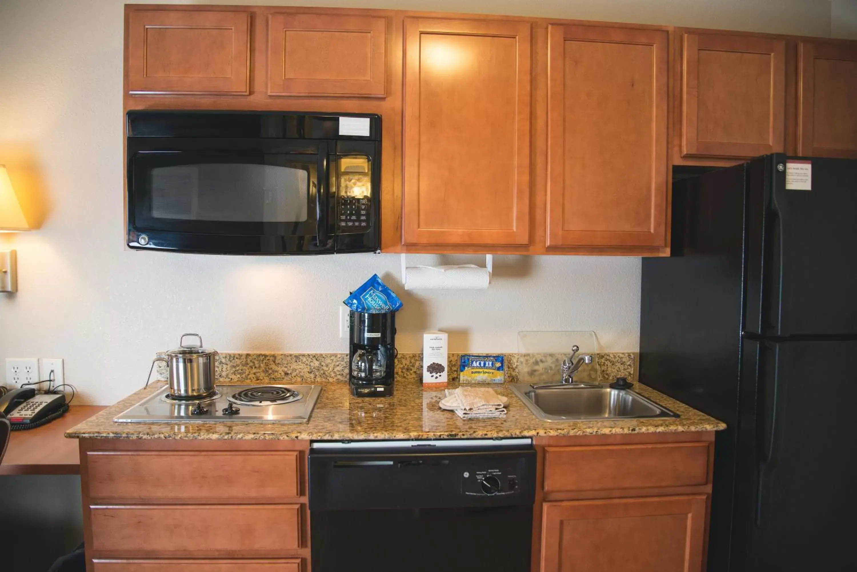 Bedroom, Kitchen/Kitchenette in Candlewood Suites Loveland, an IHG Hotel