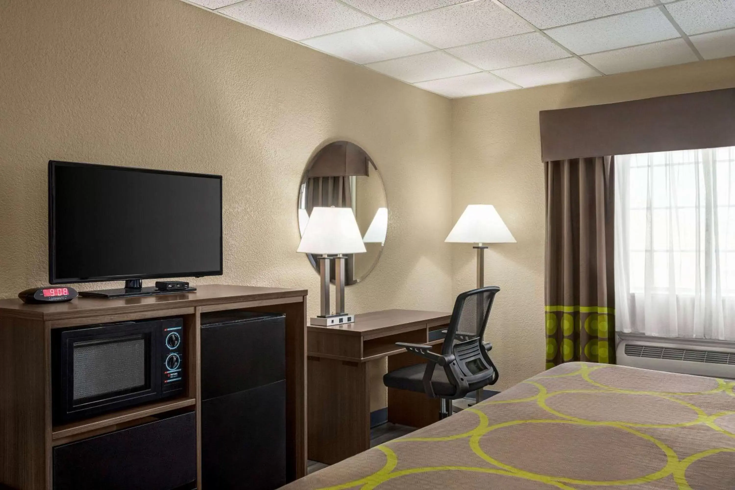 Photo of the whole room, TV/Entertainment Center in Super 8 by Wyndham Gainesville TX