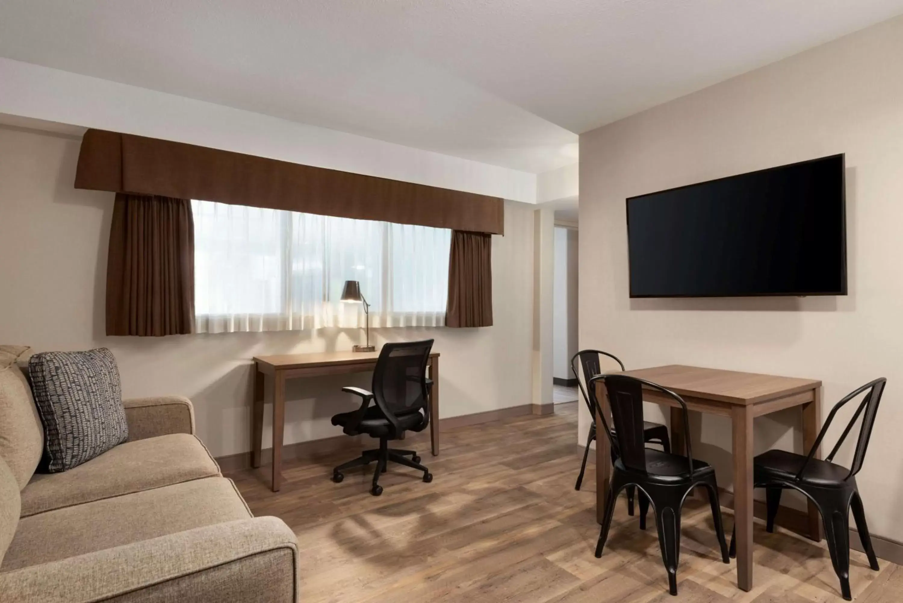 Photo of the whole room, TV/Entertainment Center in Ramada by Wyndham Airdrie Hotel & Suites