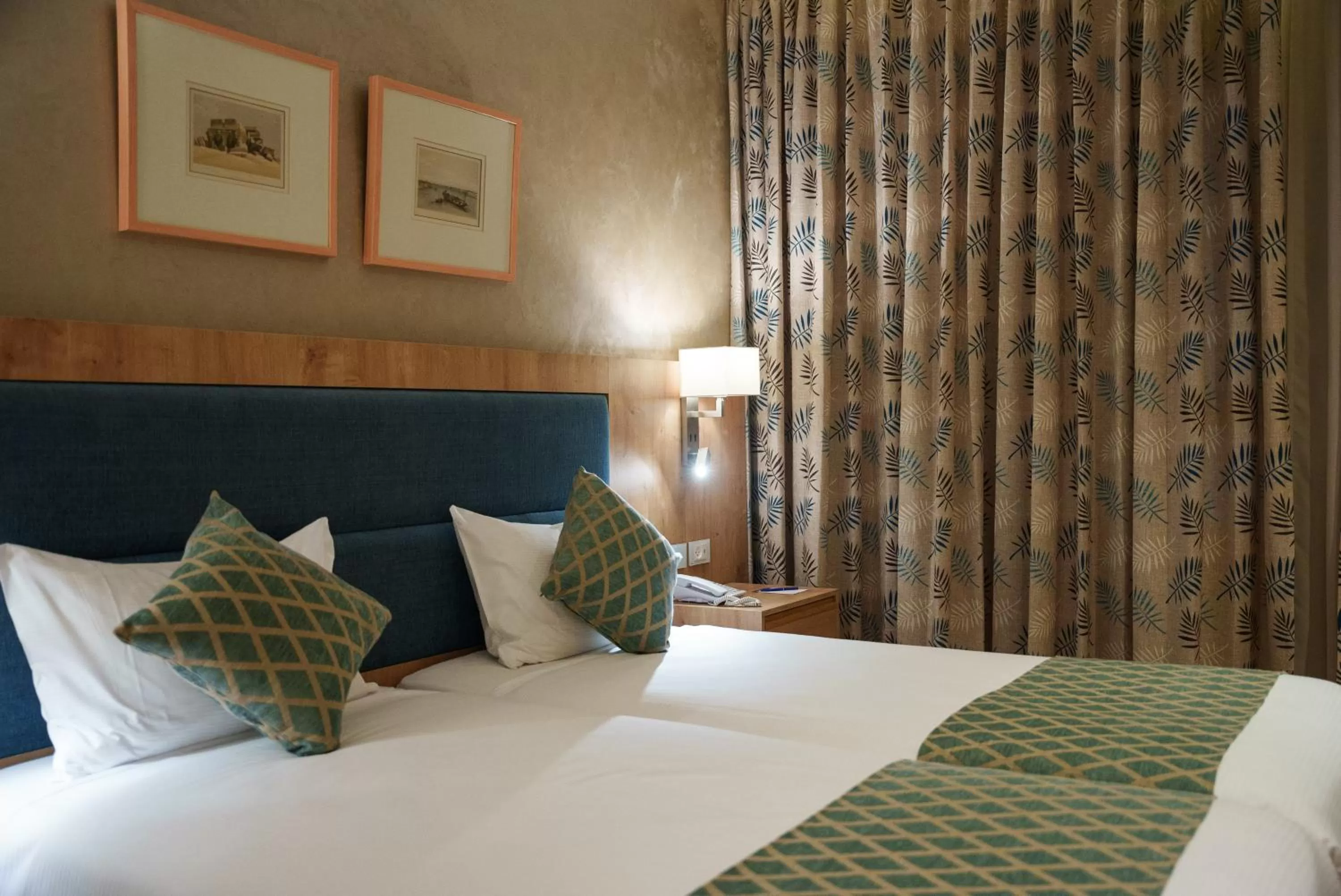 Bed in Ambassador Boutique Hotel