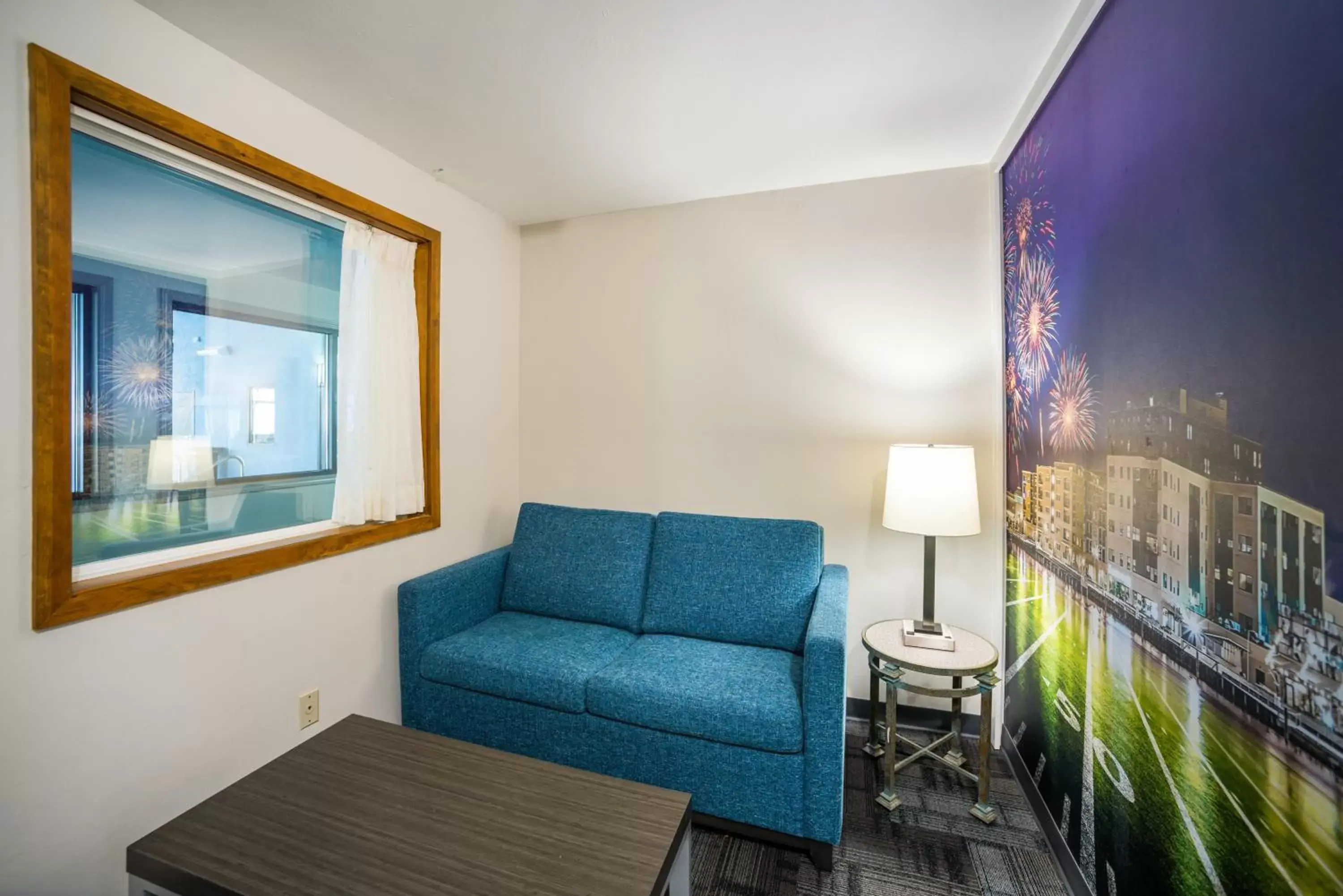 Living room in AmericInn by Wyndham Green Bay Near Stadium Living room in AmericInn by Wyndham Green Bay Near Stadium