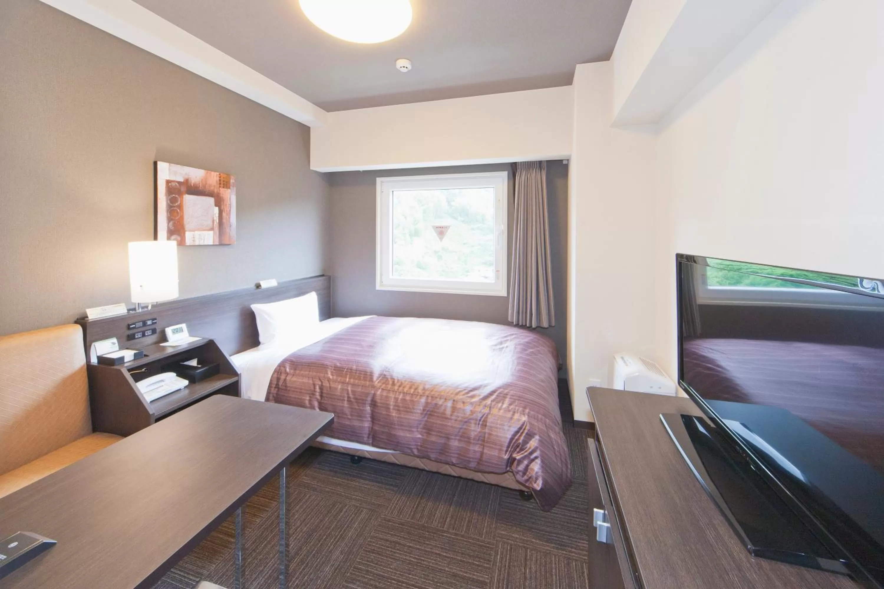 Photo of the whole room, Bed in Hotel Route-Inn Saiki Ekimae