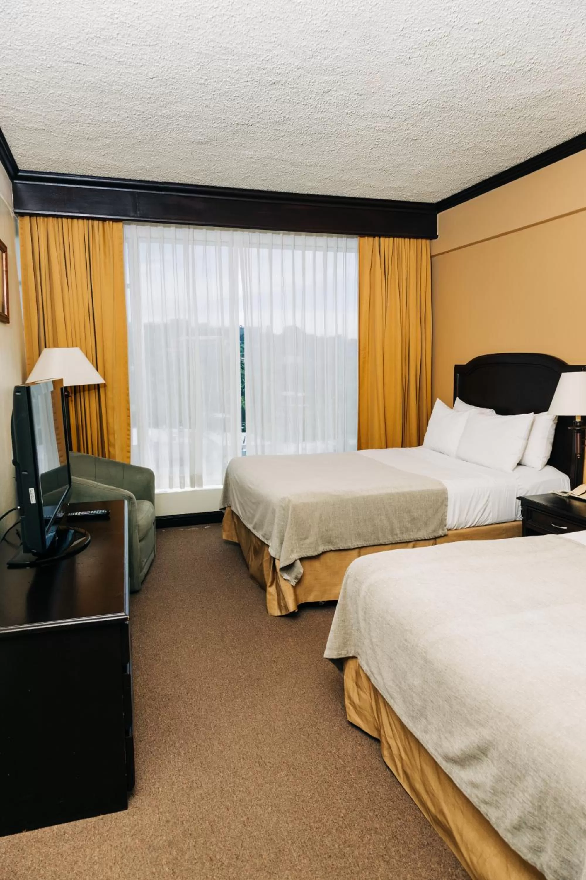 Bed in Plaza Hotel and Suites