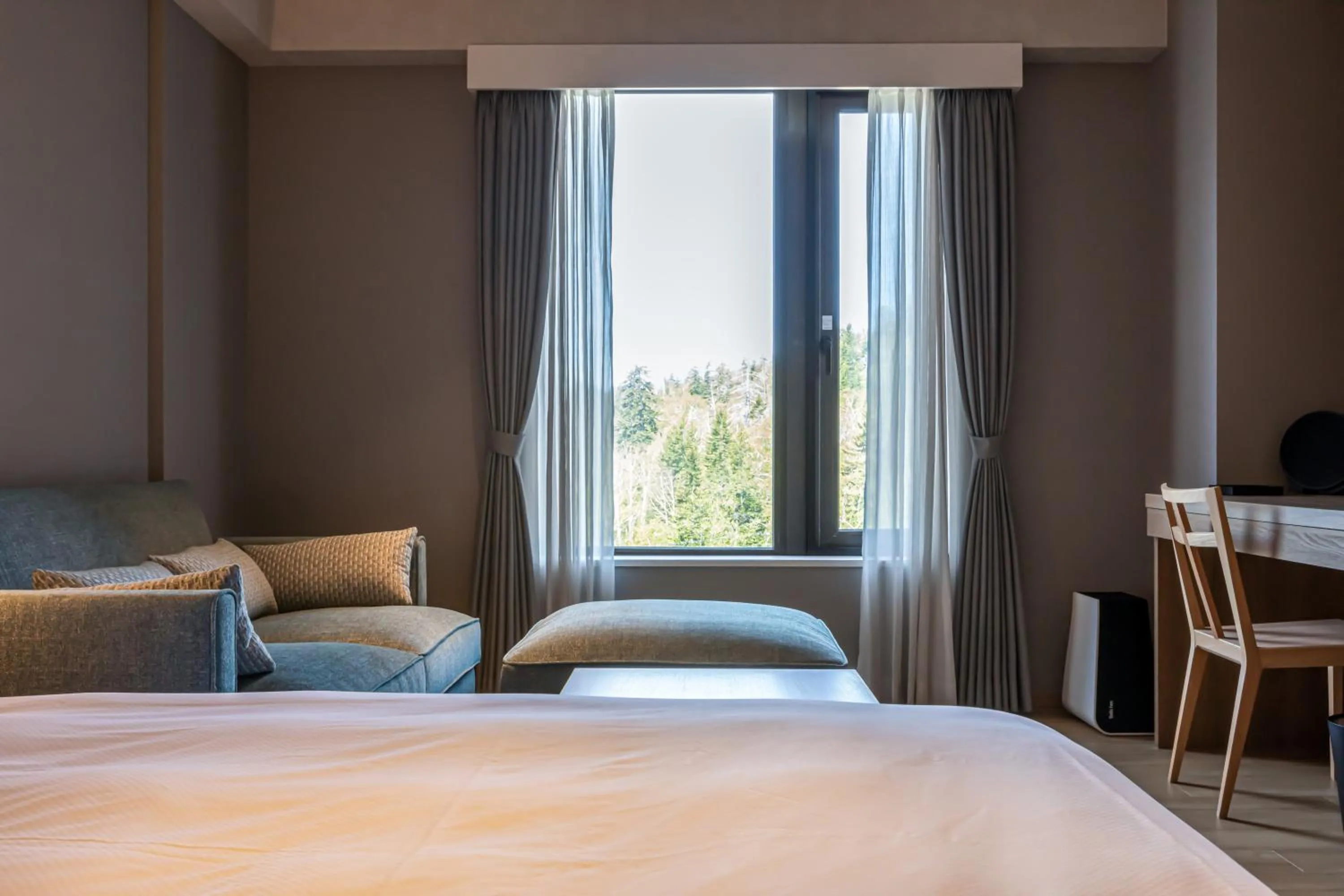 Living room, Bed in Higashikawa Asahidake Onsen Hotel Bear Monte