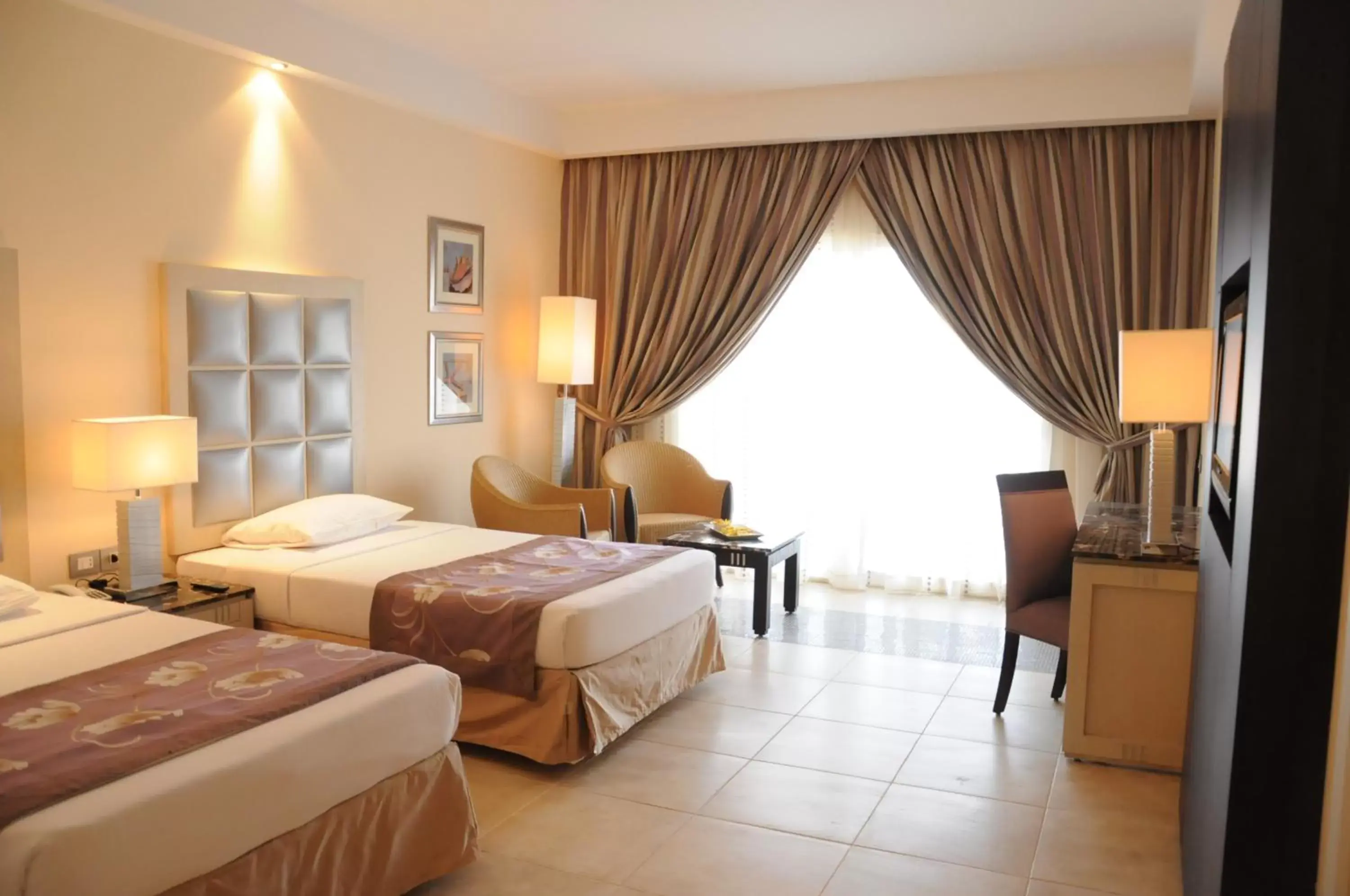 Photo of the whole room, Bed in Tropitel Sahl Hasheesh