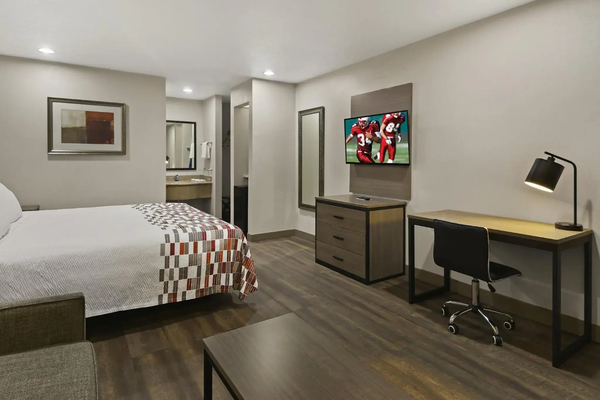 Photo of the whole room, TV/Entertainment Center in Red Roof Inn & Suites Irving - DFW Airport South