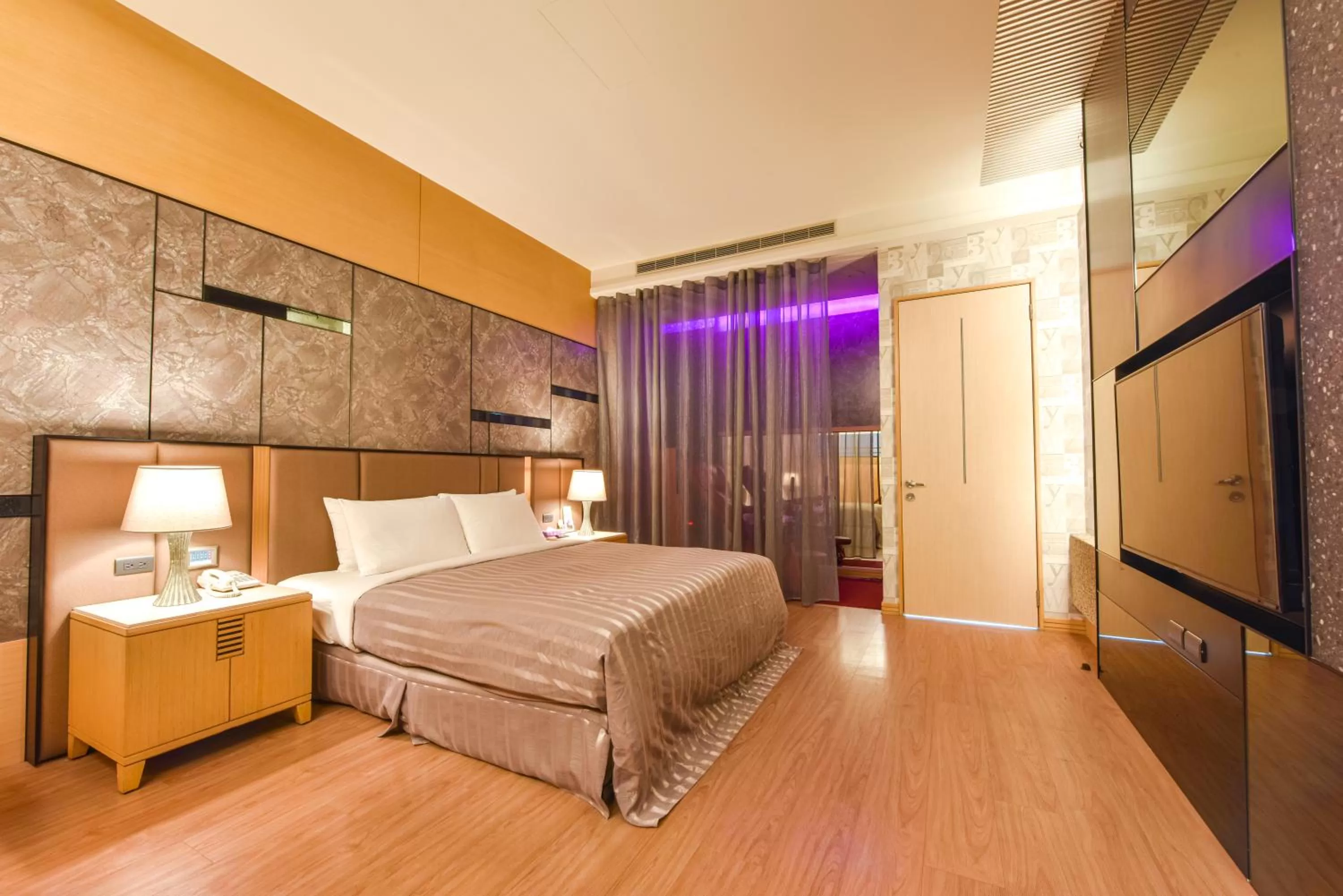 Bed in Purple Garden Motel