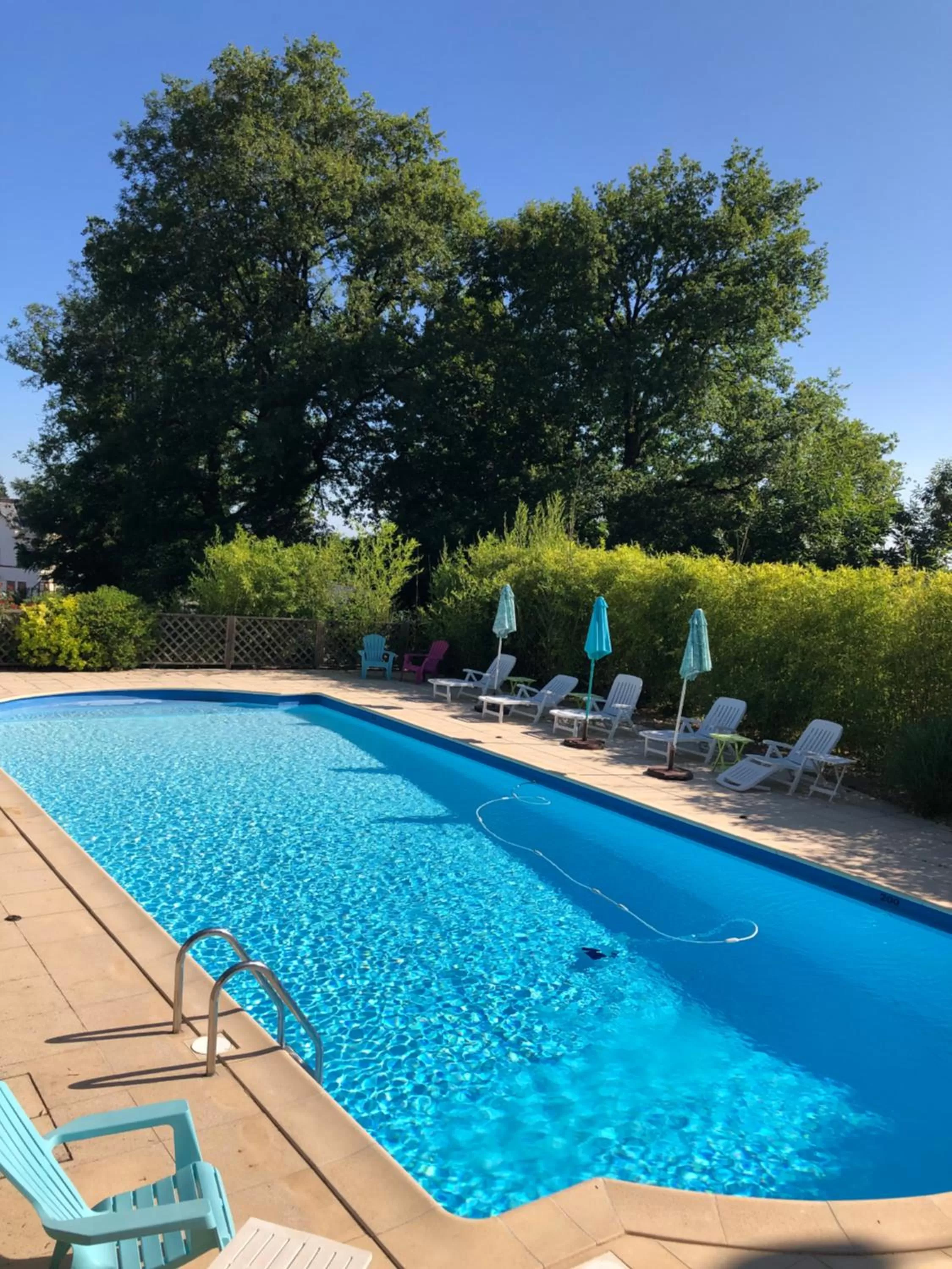 Swimming pool in Logis Hôtel-Restaurant Le Commerce