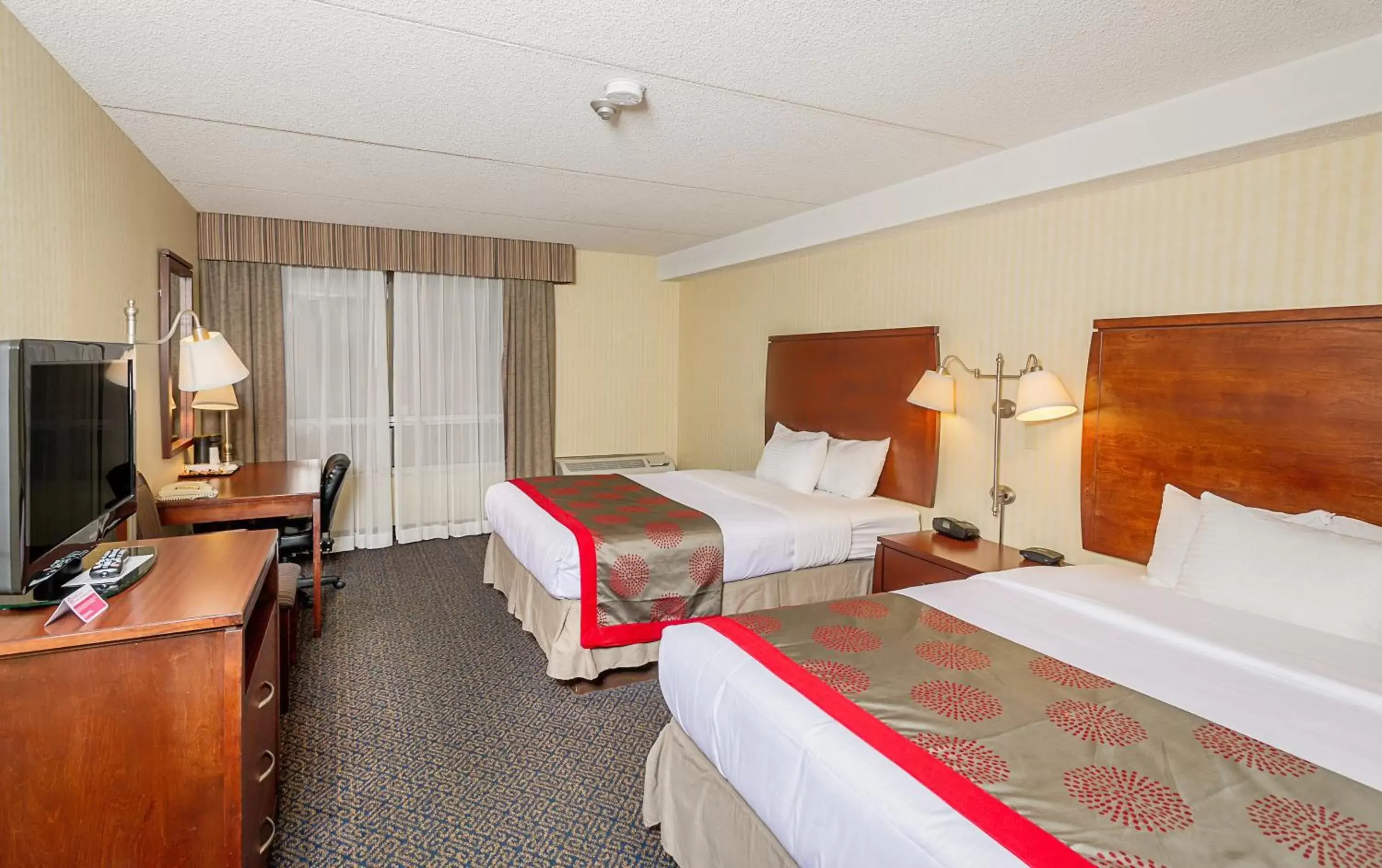 Photo of the whole room, Bed in Ramada by Wyndham Niagara Falls by the River