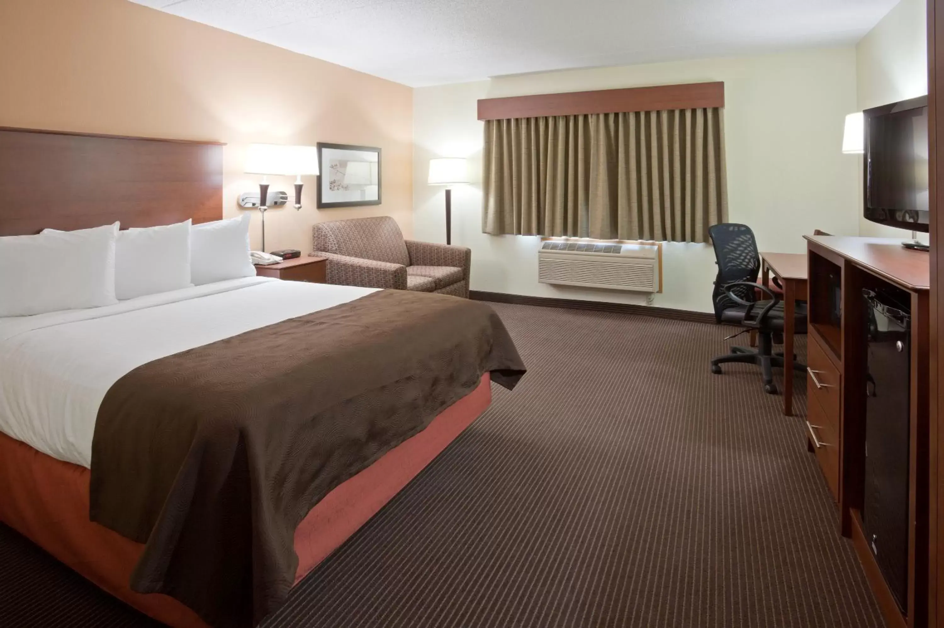 Bed in AmericInn by Wyndham Bismarck