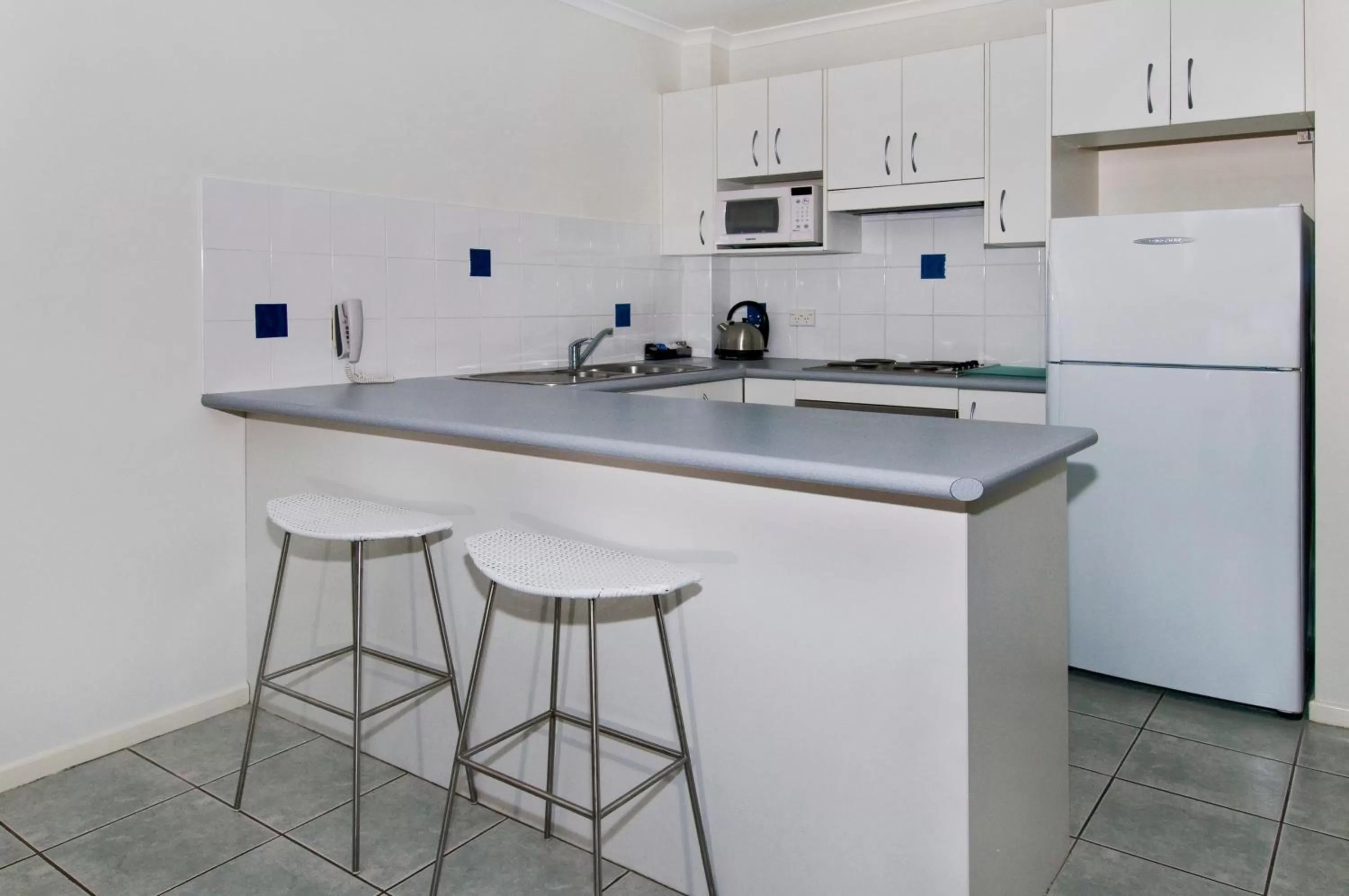 Kitchen or kitchenette in South Pacific Apartments