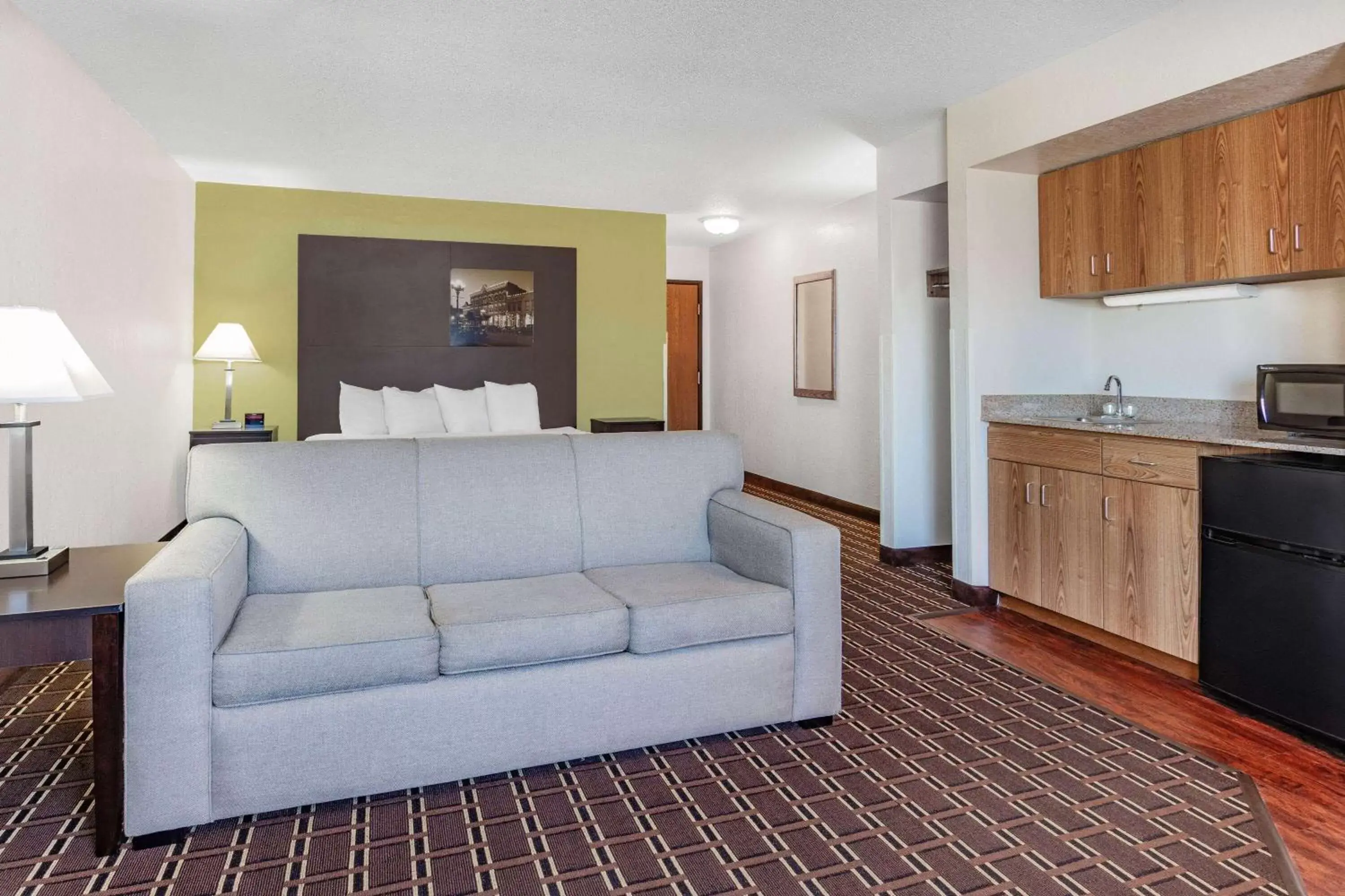 Bed, Seating Area in Super 8 by Wyndham La Crosse