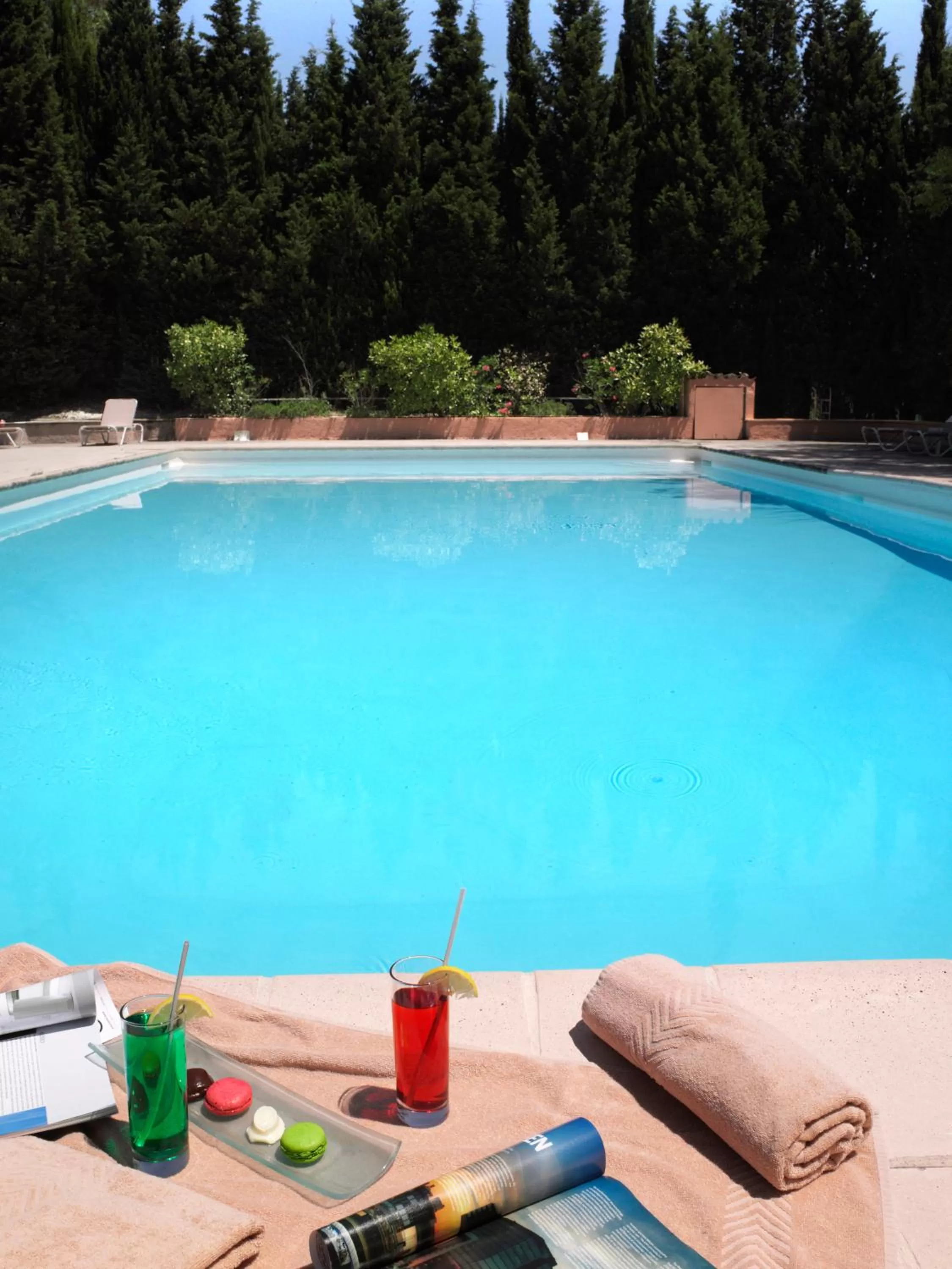 Swimming pool in Hôtel Golf & Spa Château de la Bégude The Originals Collection