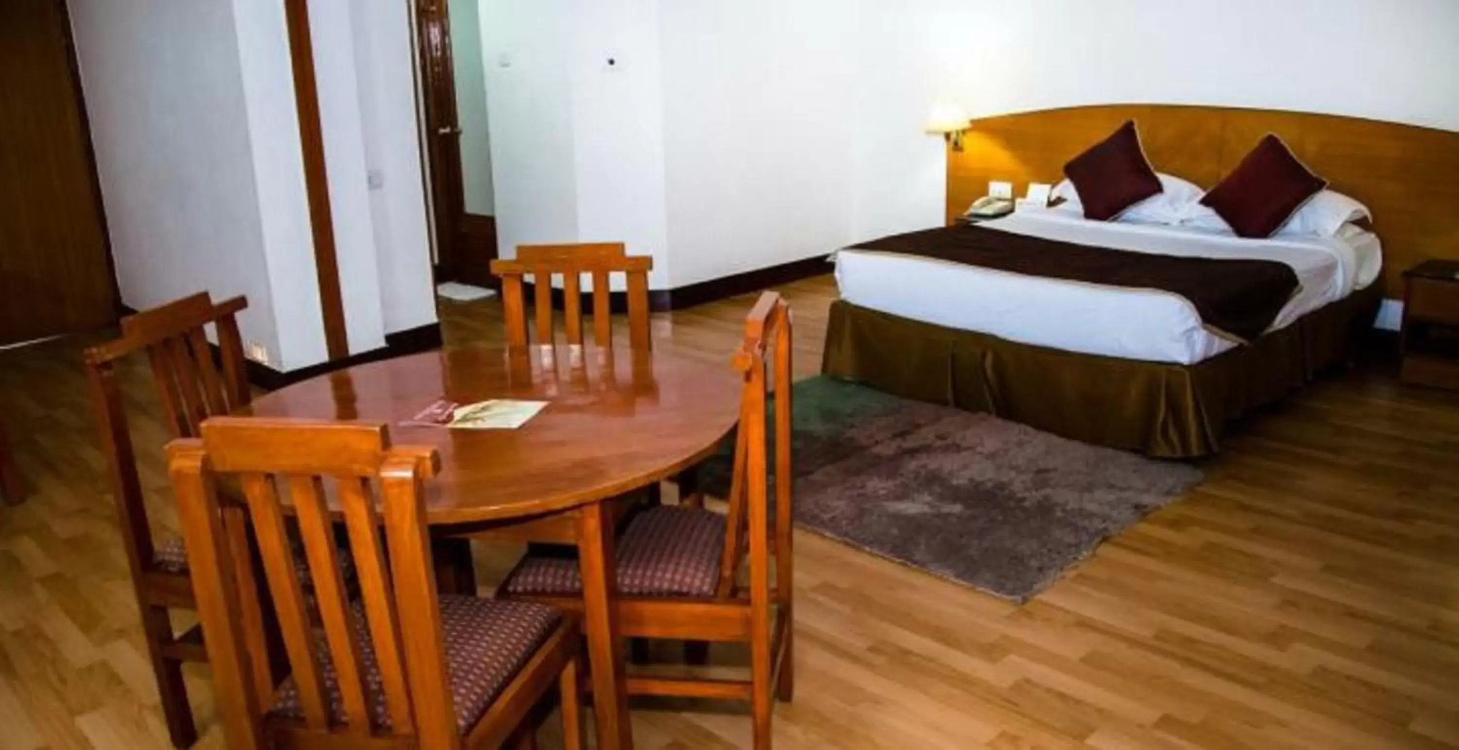 Living room, Bed in Ramee Guestline Tirupati