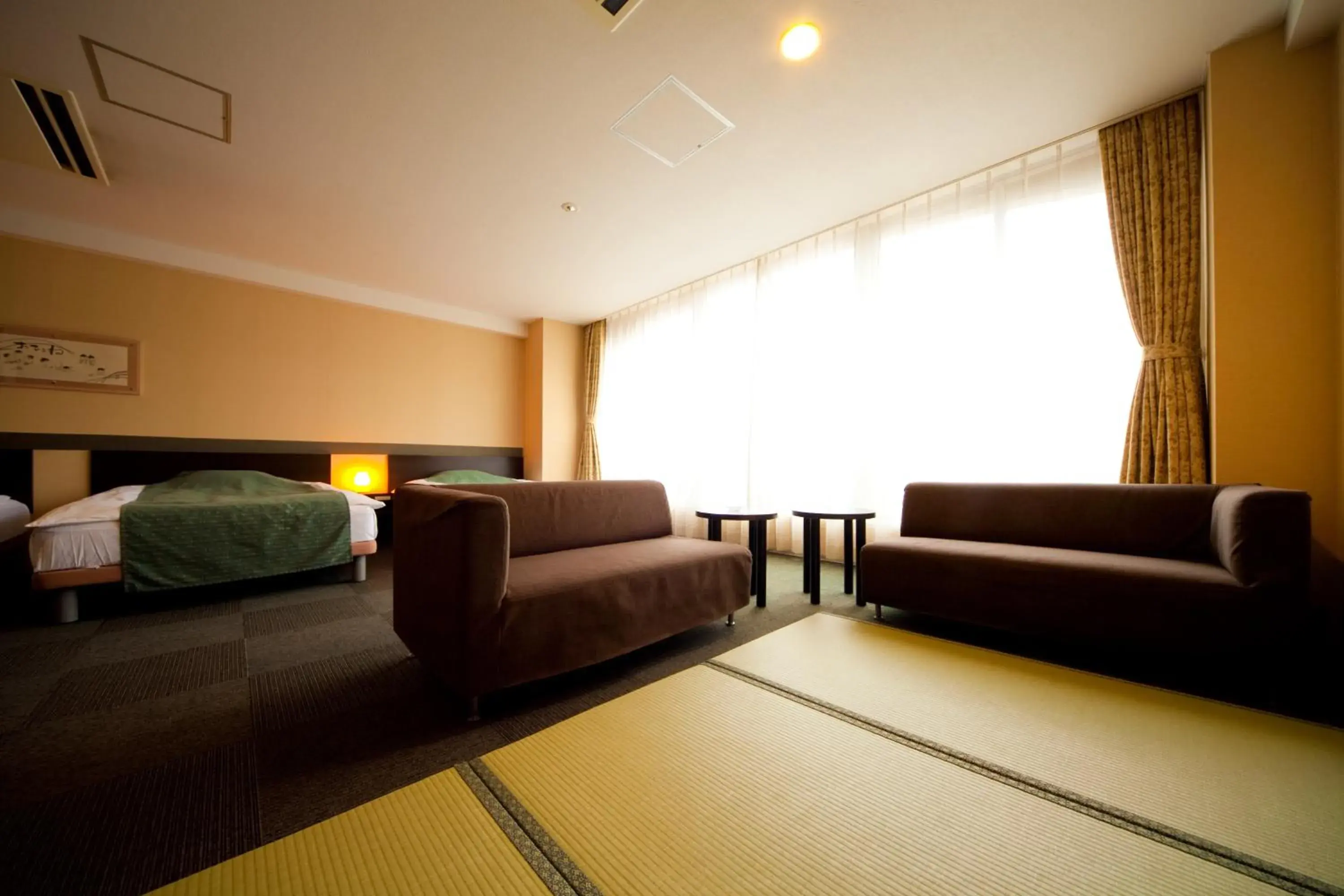 Bed, Seating Area in Hotel Aile