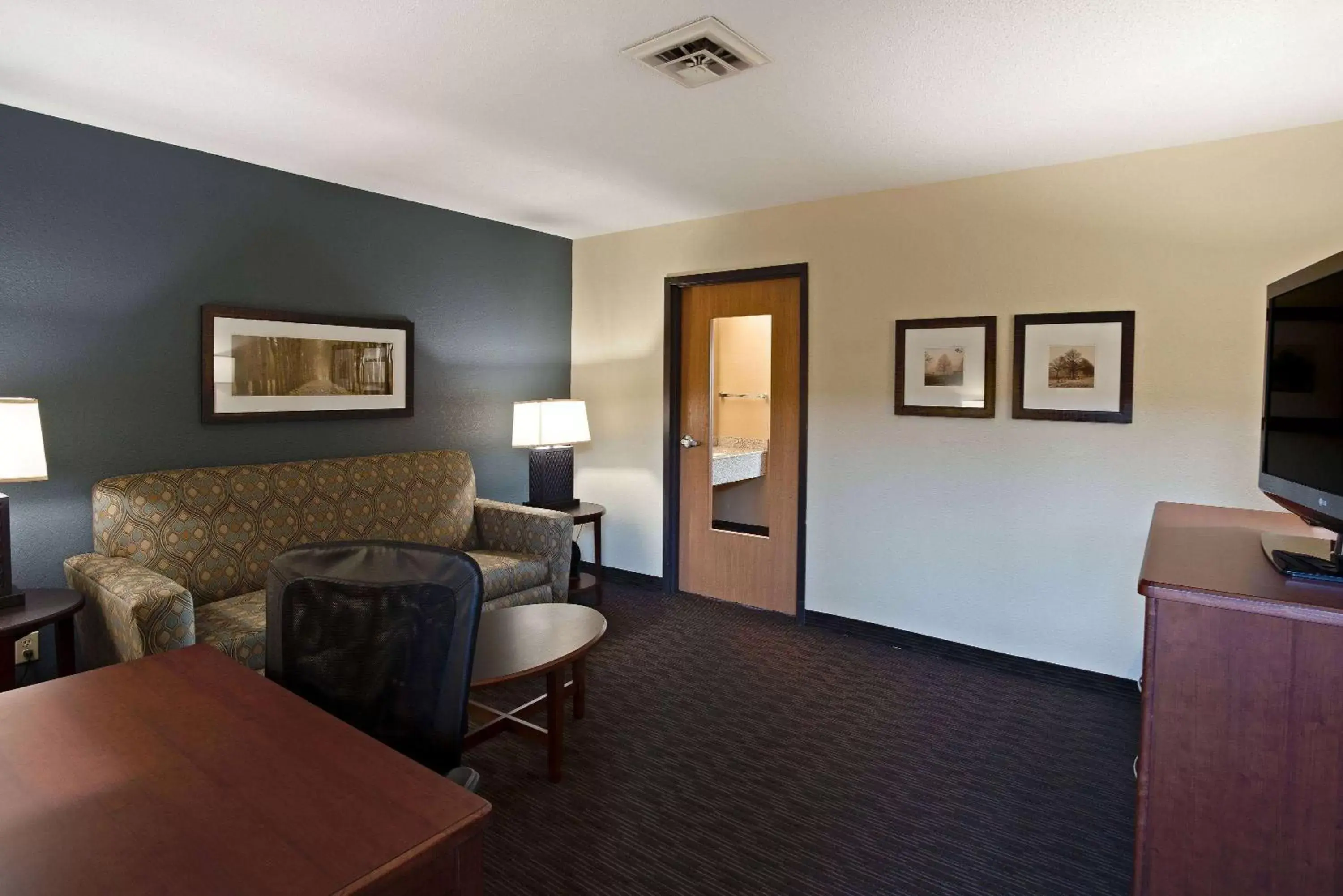 Photo of the whole room, Seating Area in AmericInn by Wyndham Bay City