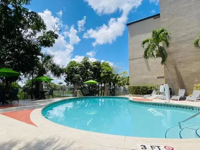 Property building, Swimming Pool in The Palms Inn & Suites Miami, Kendall, FL