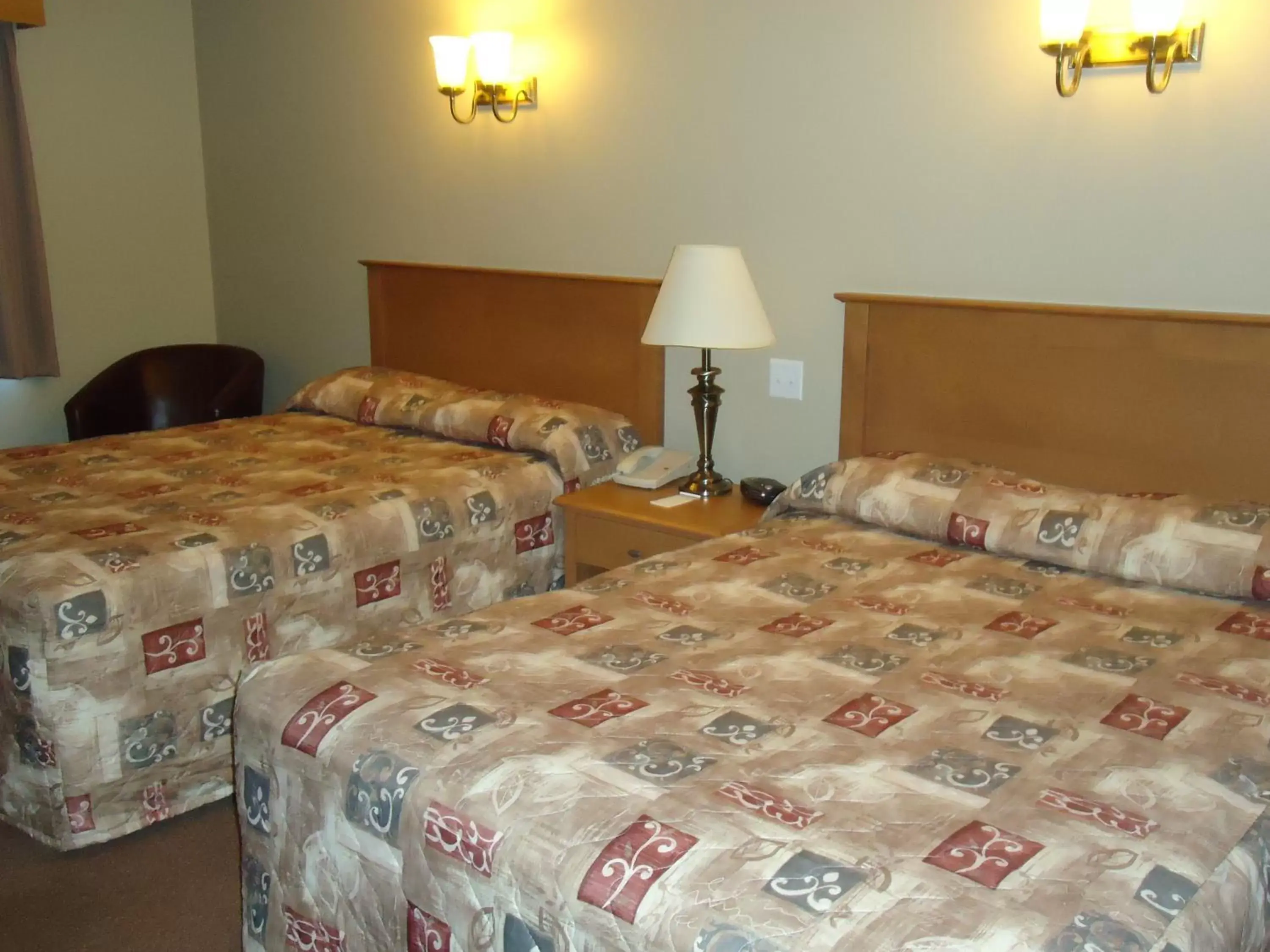 Bed in Auberge Bouctouche Inn & Suites