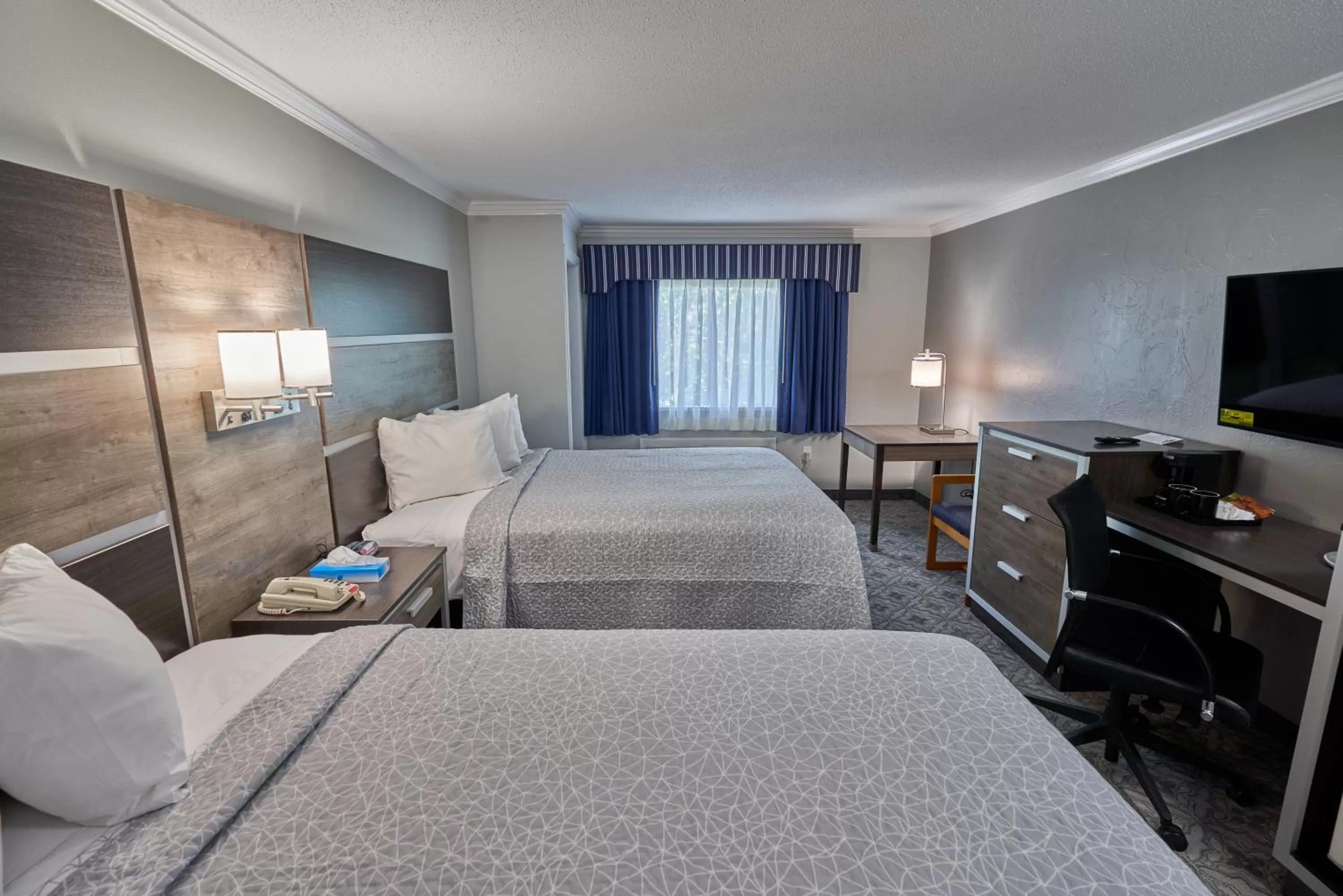 Bed in Ambassador Inn and Suites