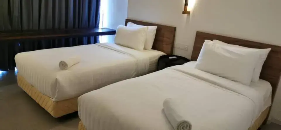 Bed in T+ PREMIUM HOTEL