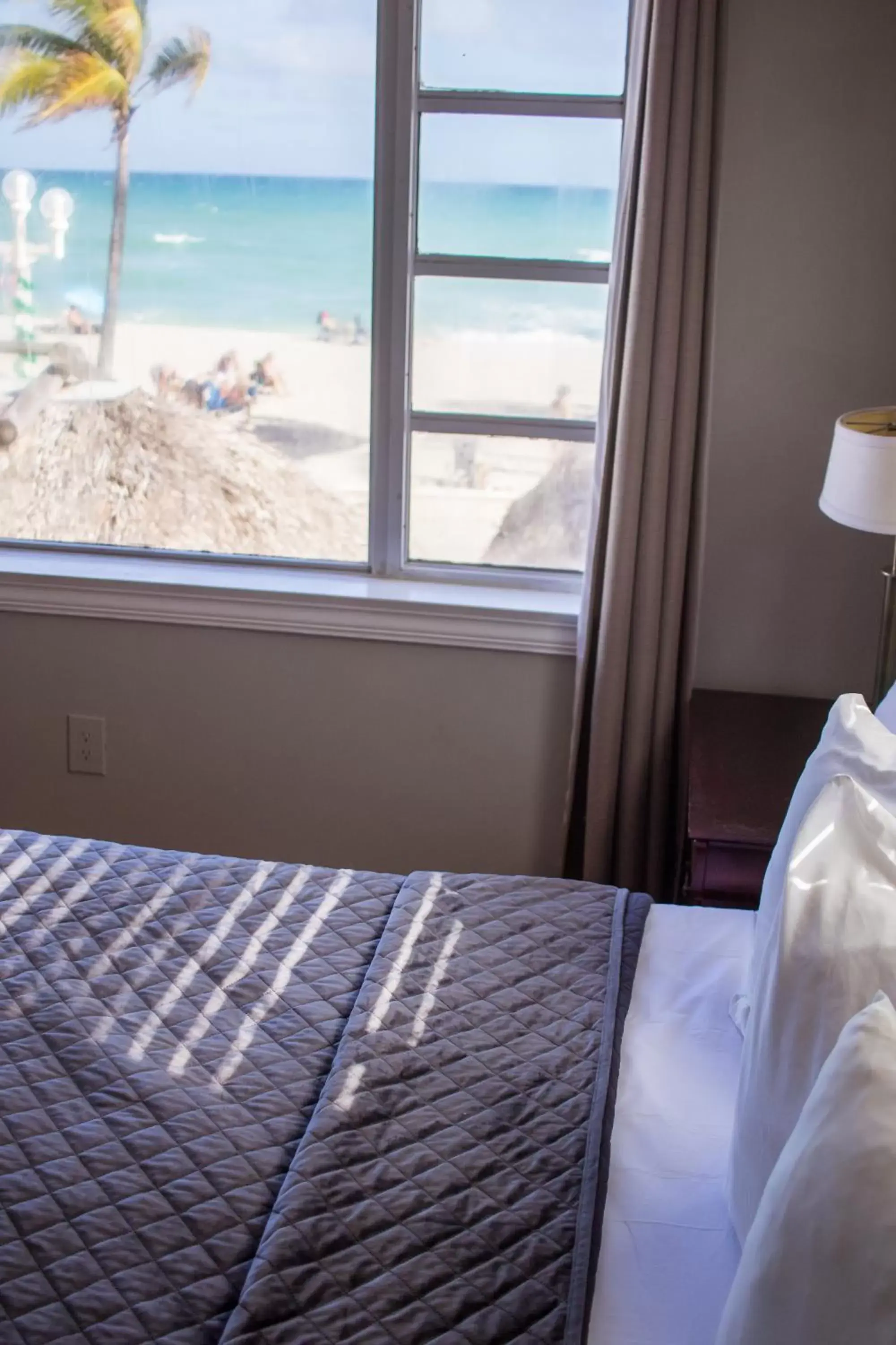 Bed in Riptide Oceanfront Hotel