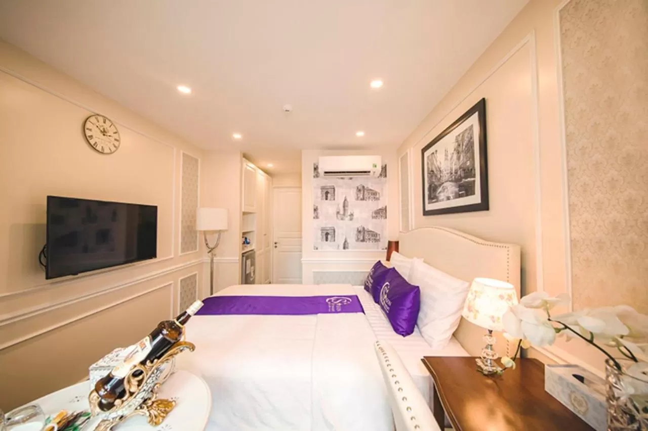 Bed in Saigon By Night Luxury Hotel