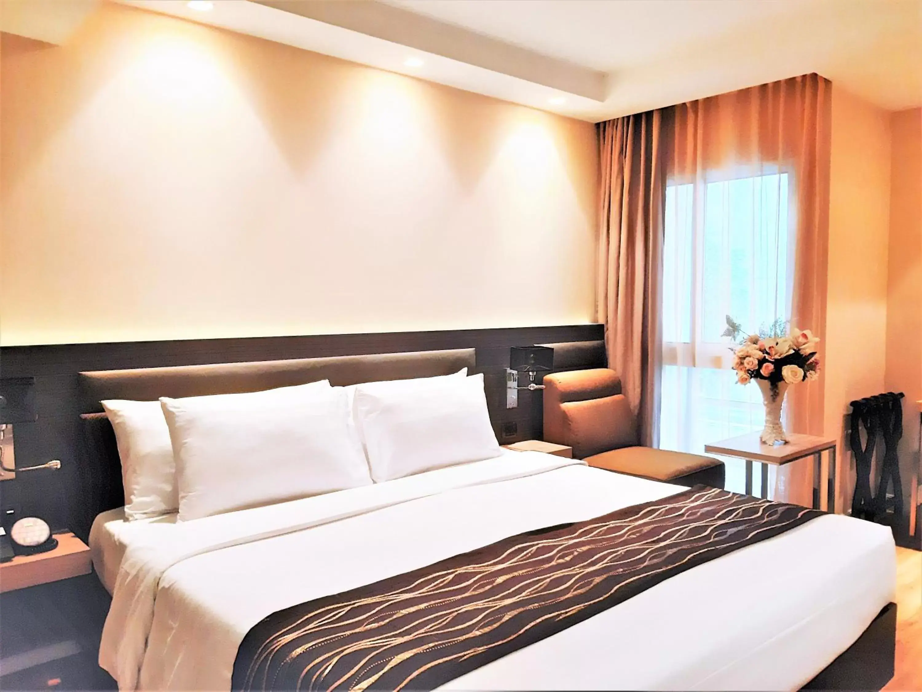 Bed in Amora NeoLuxe Suites Hotel