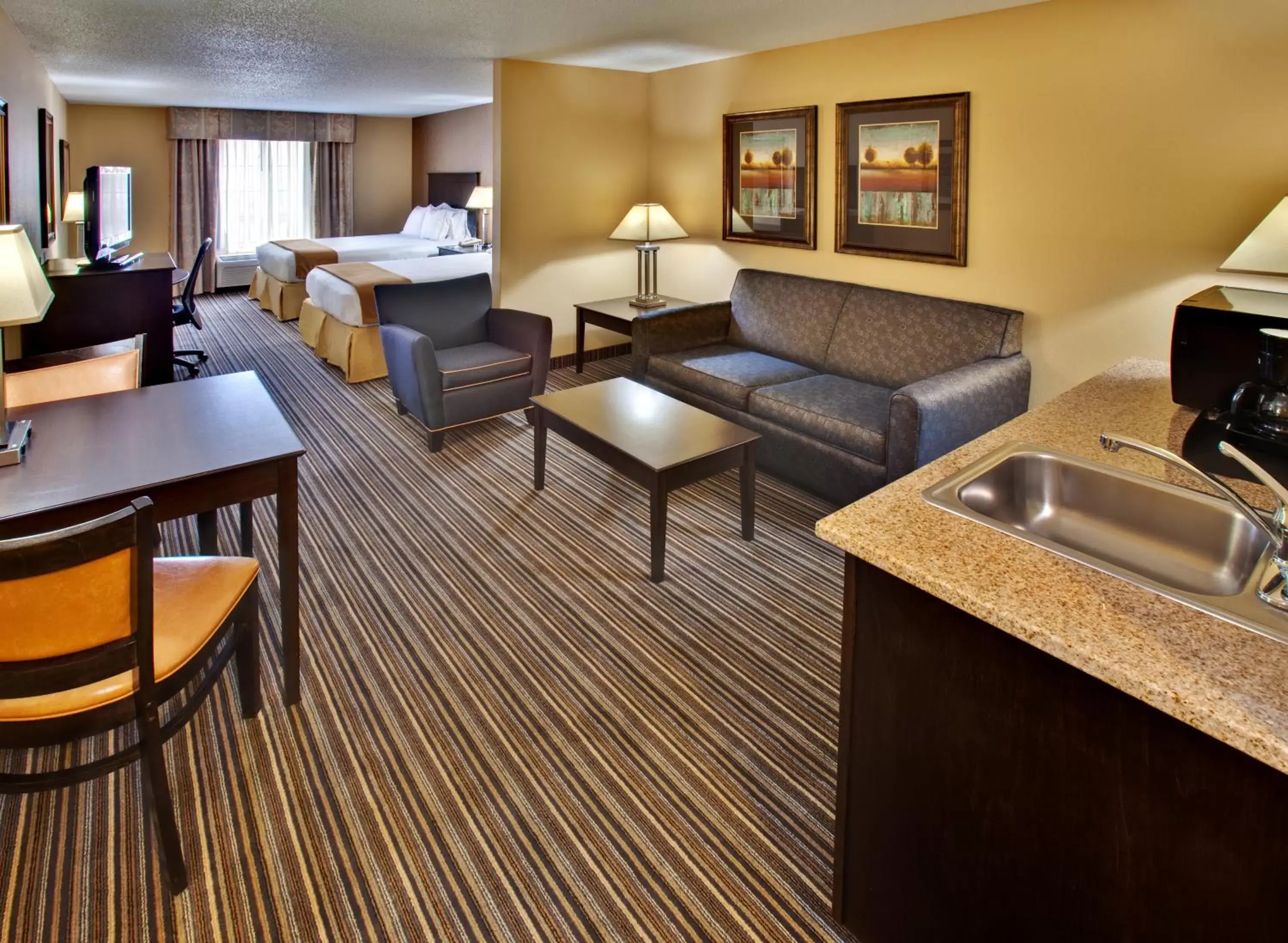 Bedroom, Seating Area in Holiday Inn Express Hotel & Suites Council Bluffs - Convention Center Area, an IHG Hotel