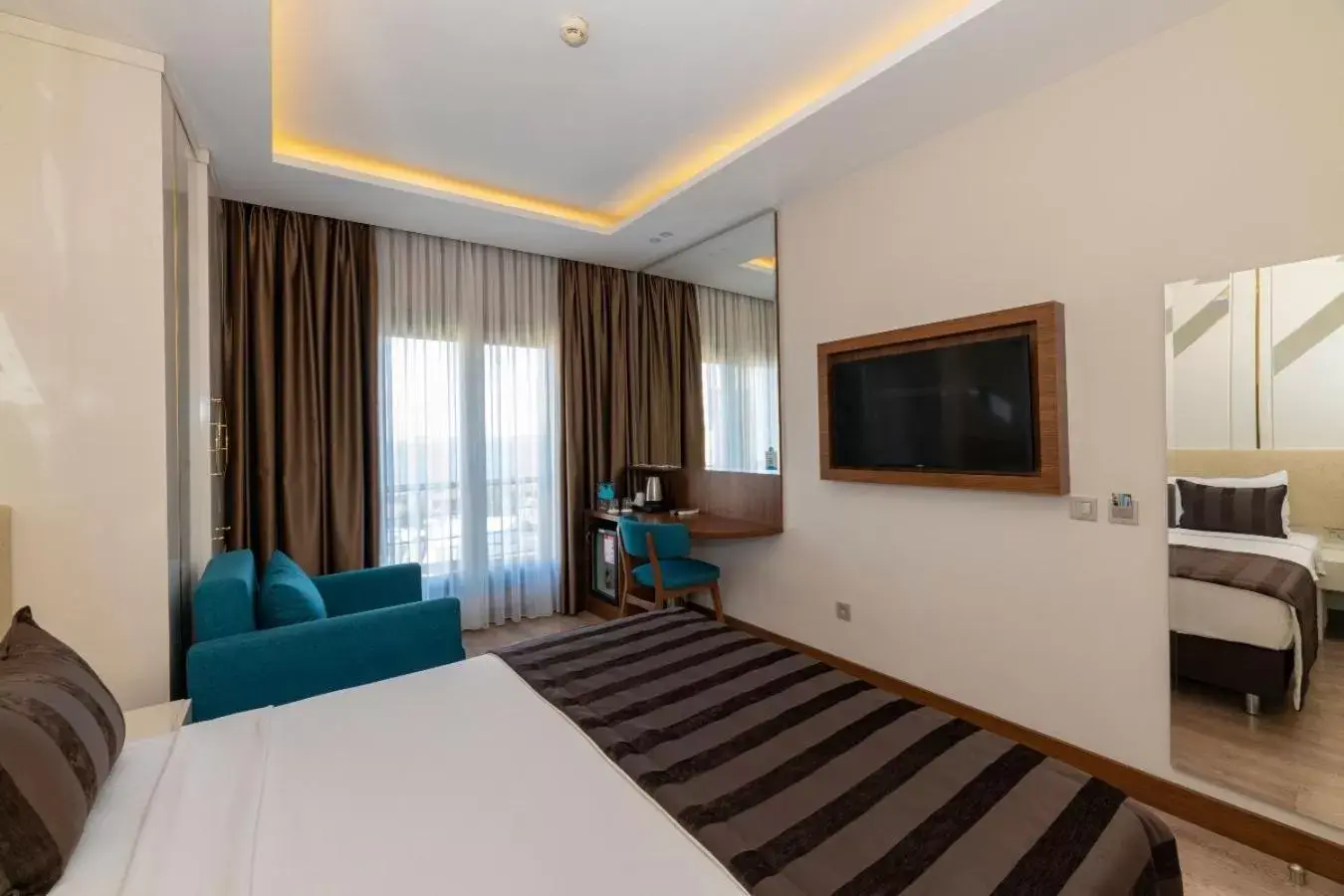Bedroom, TV/Entertainment Center in The Byzantium Suites Hotel & Spa