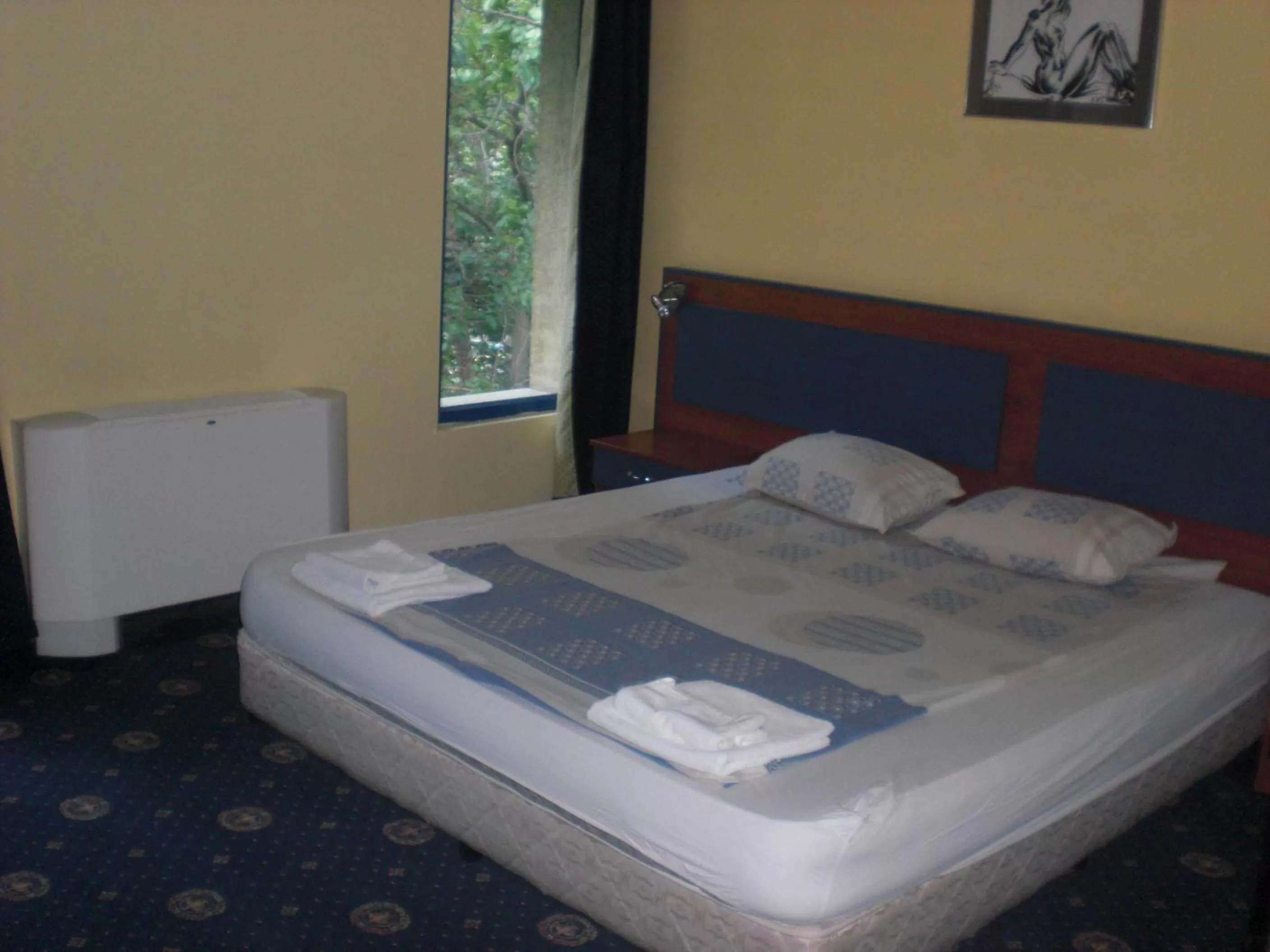Bed in Fenix Family Hotel