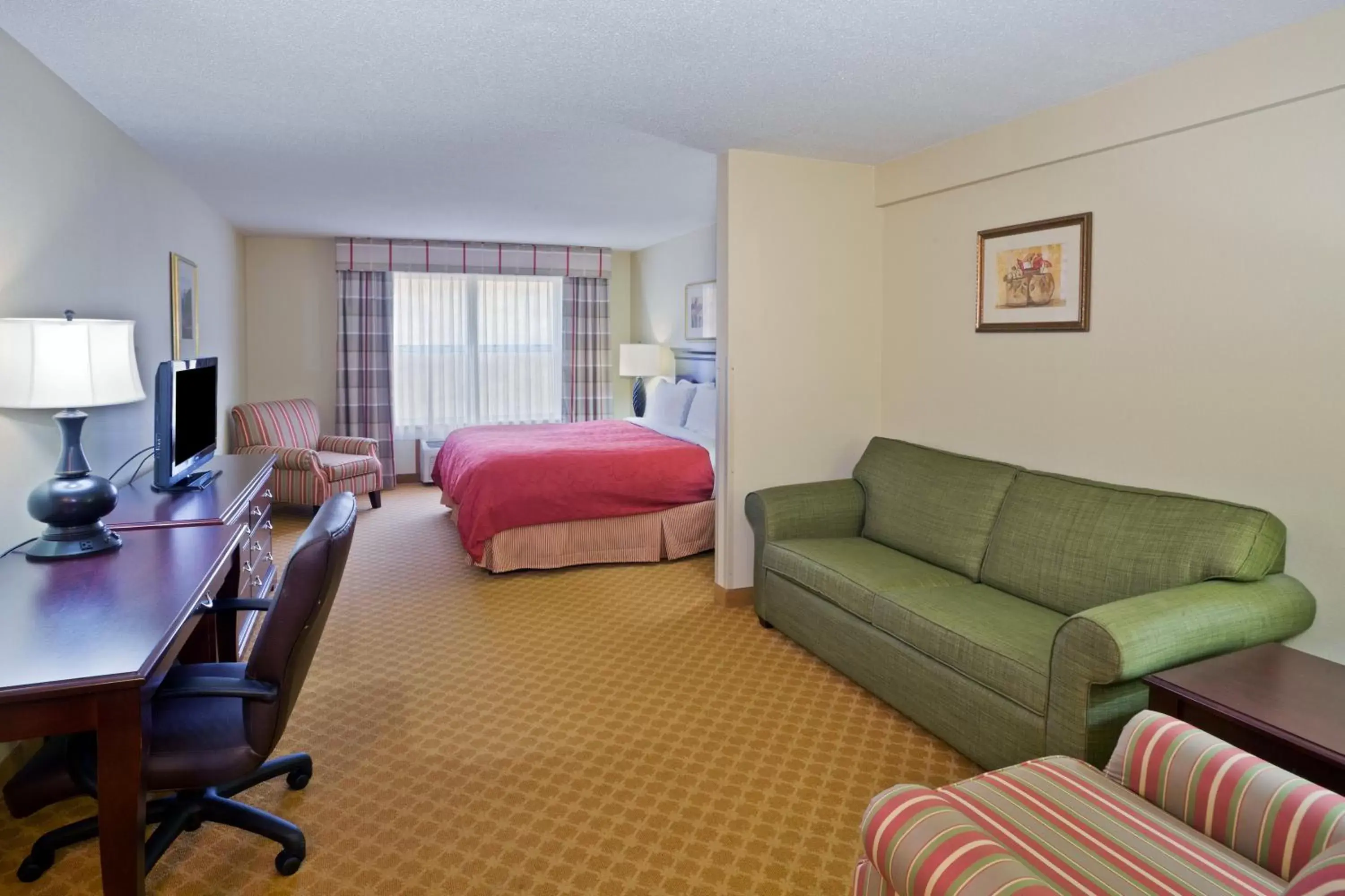 Photo of the whole room, Seating Area in AmericInn by Wyndham Iron Mountain