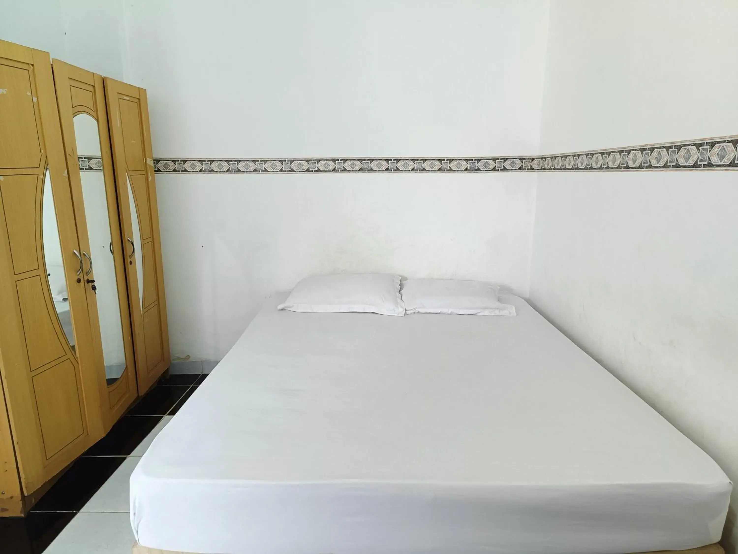 Bed in OYO 90260 Bumi Merpati Residence