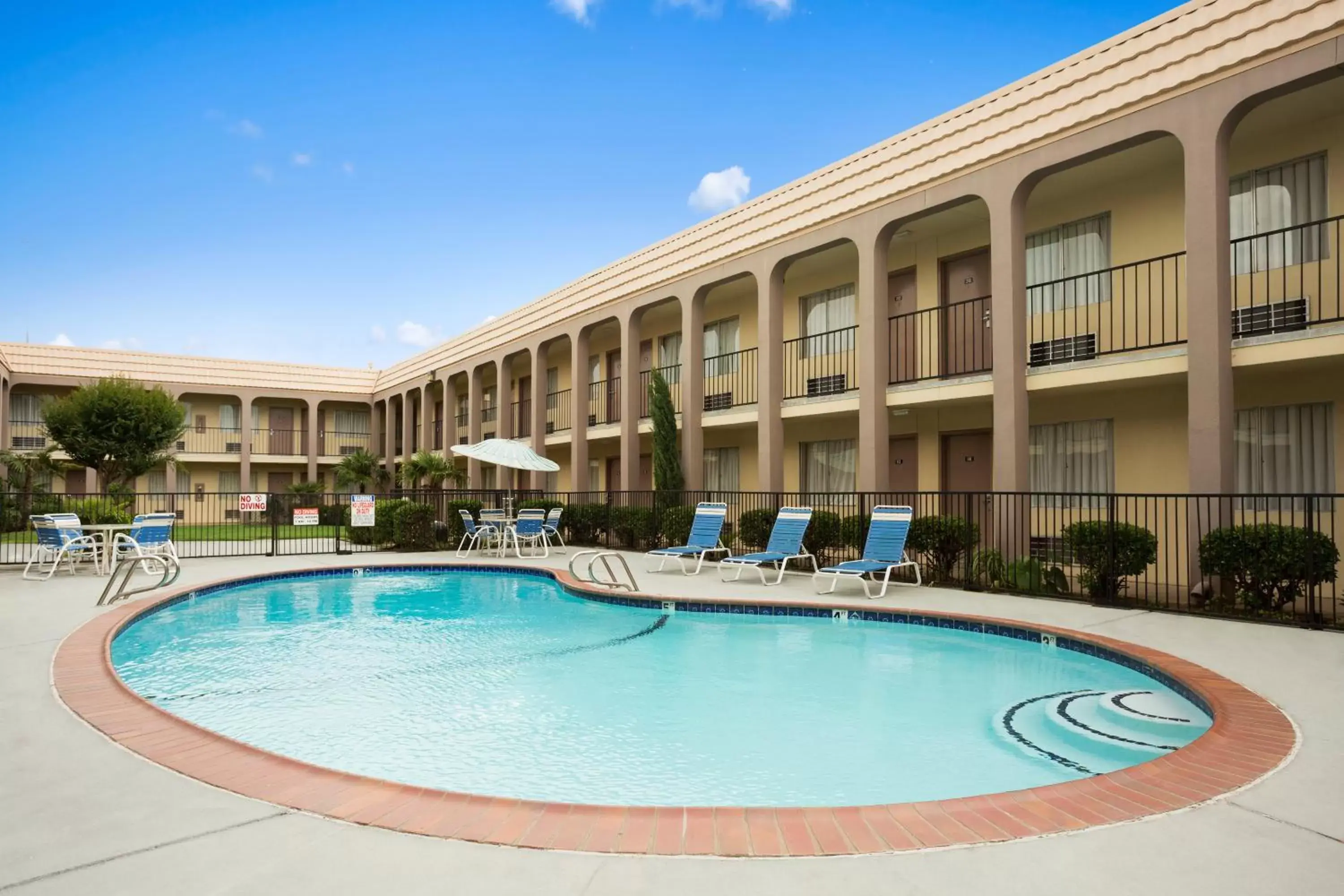 Swimming pool, Property Building in Days Inn by Wyndham Dallas Irving