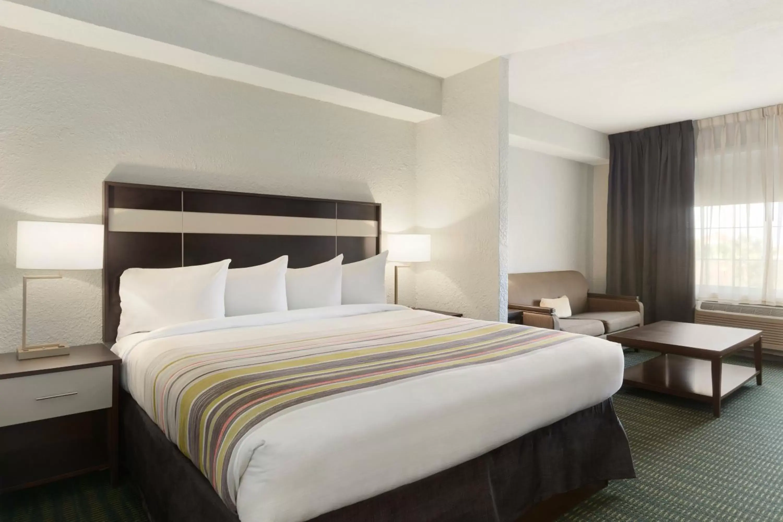 Seating area, Bed in SureStay Plus Hotel by Best Western Vero Beach