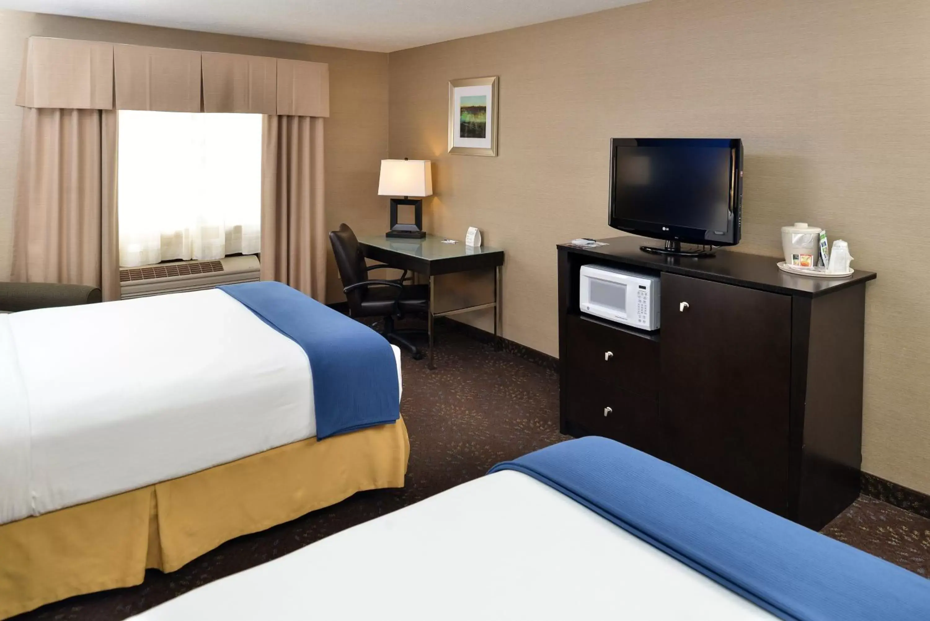 Photo of the whole room, TV/Entertainment Center in Holiday Inn Express Hotel & Suites Charlotte, an IHG Hotel