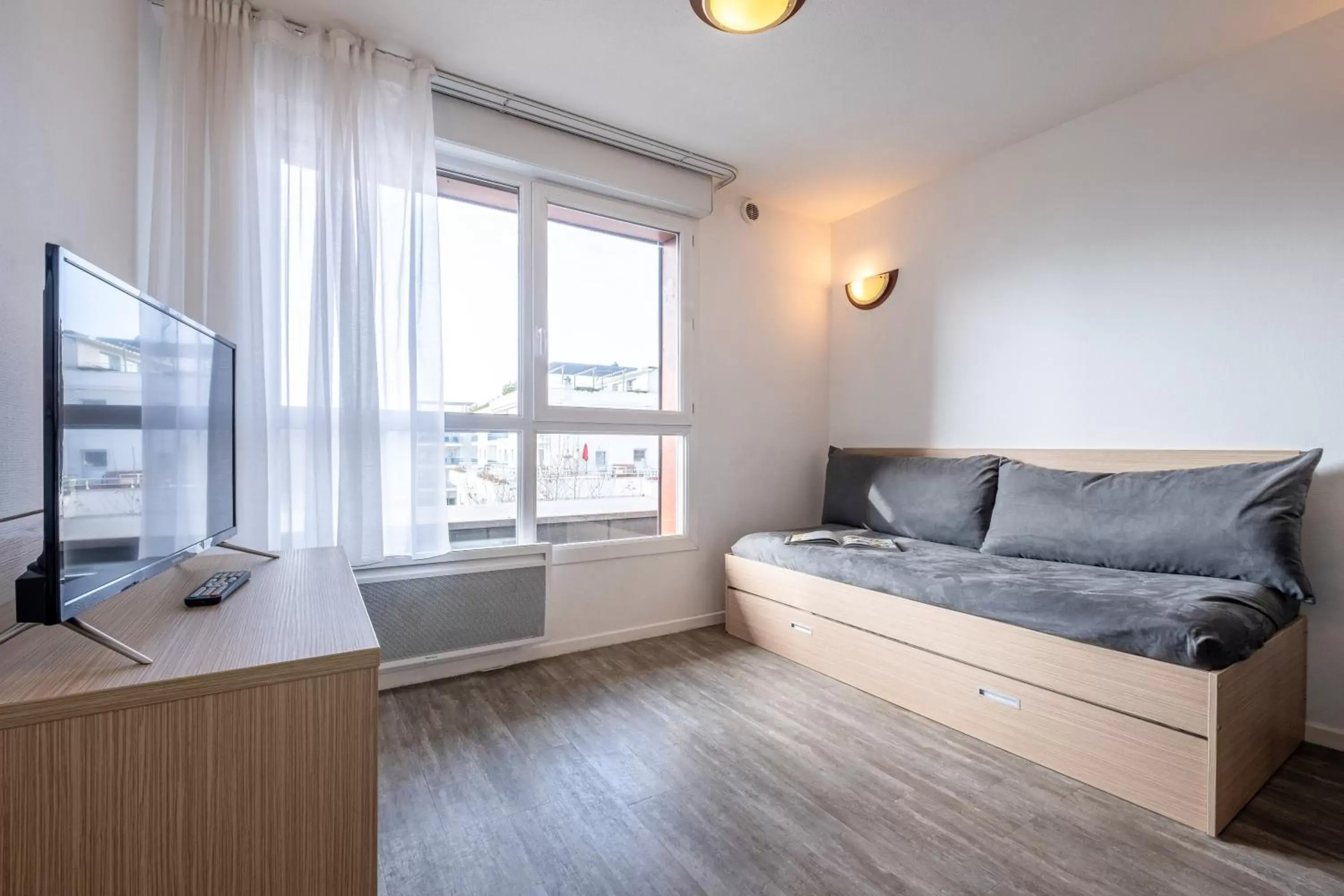 Living room, Bed in Zenitude Hôtel-Résidences Les Hauts d'Annecy Living room, Bed in Zenitude Hôtel-Résidences Les Hauts d'Annecy