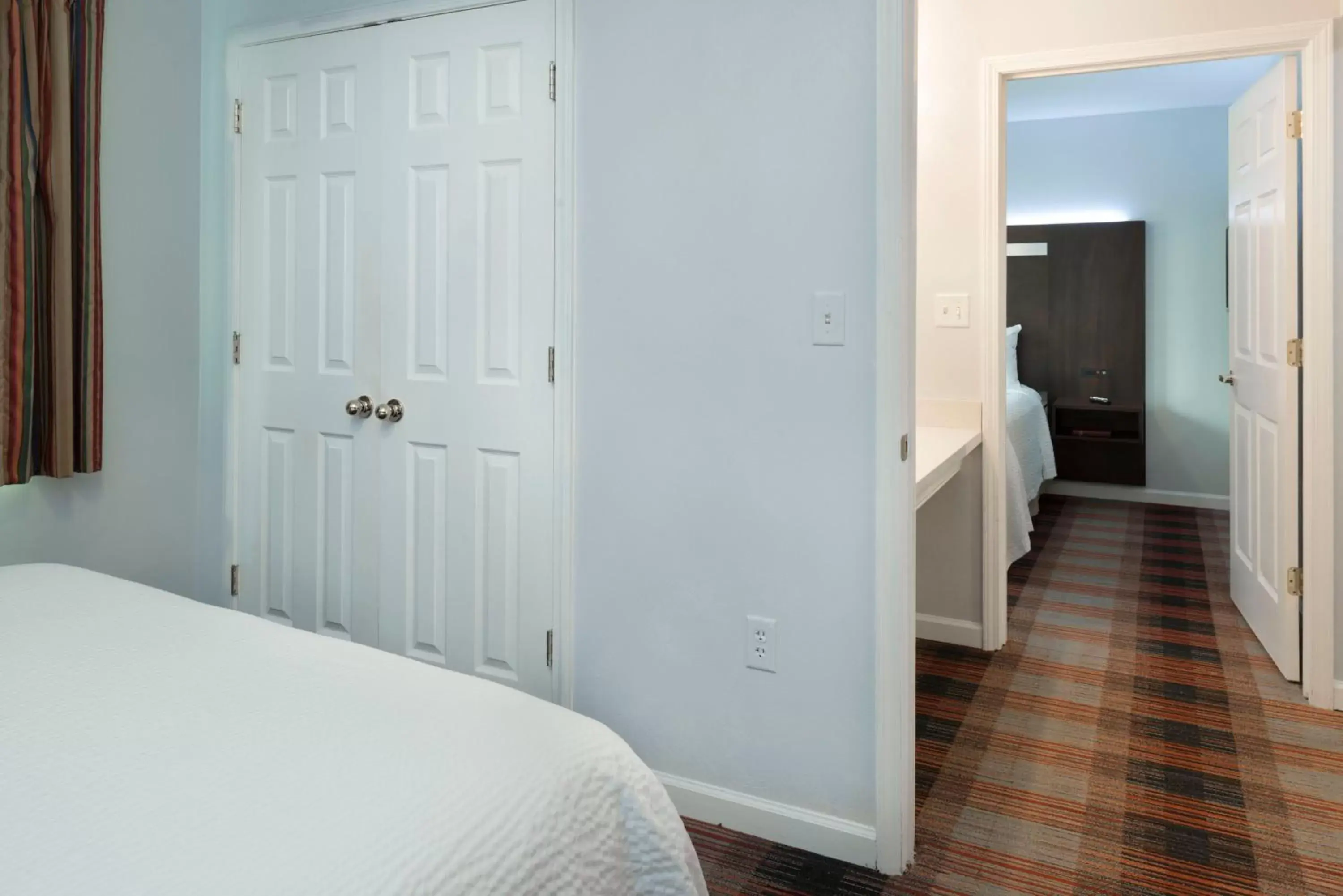 Bed in Luxbury Inn & Suites