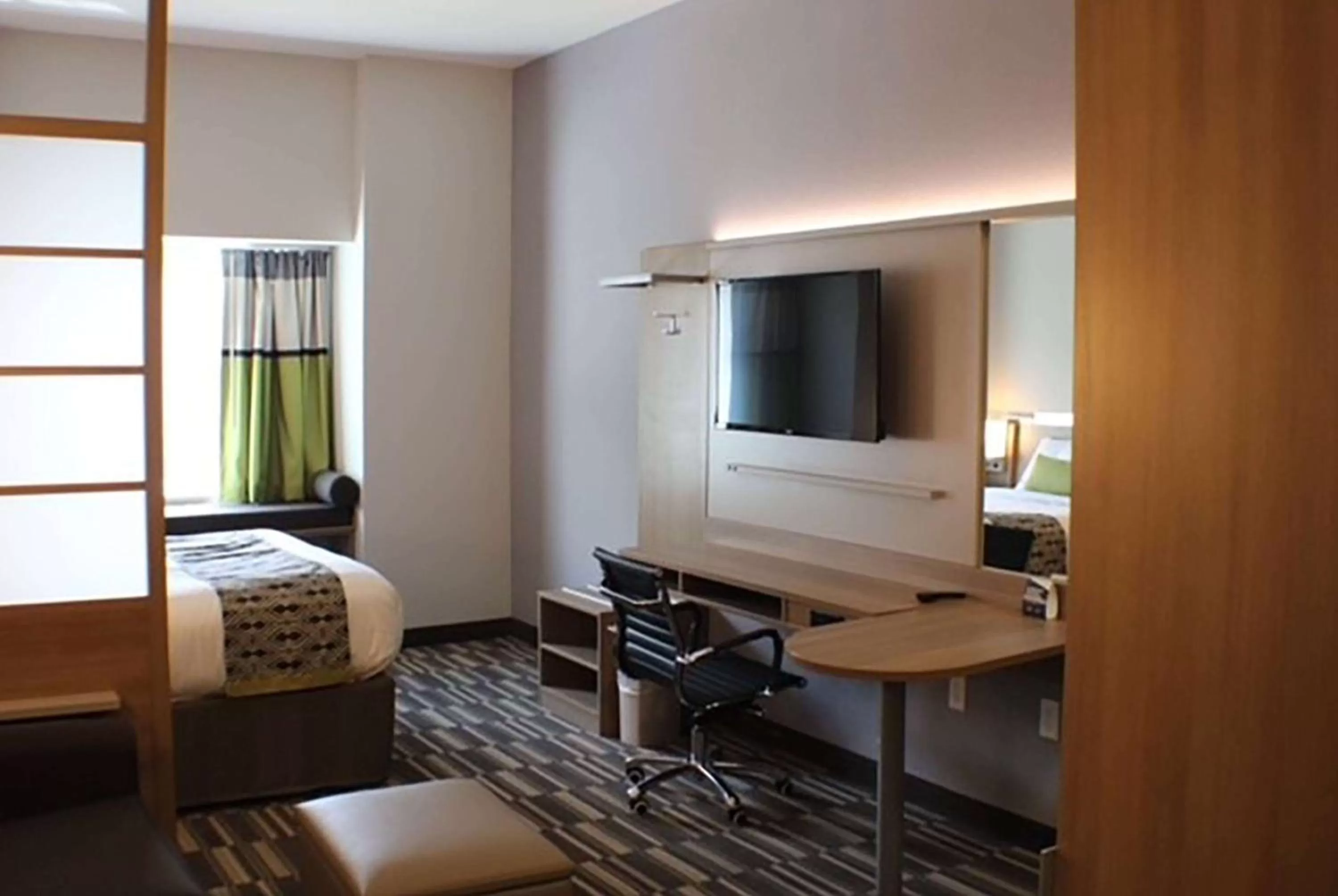 Photo of the whole room, TV/Entertainment Center in Microtel Inn & Suites by Wyndham Liberty NE Kansas City Area